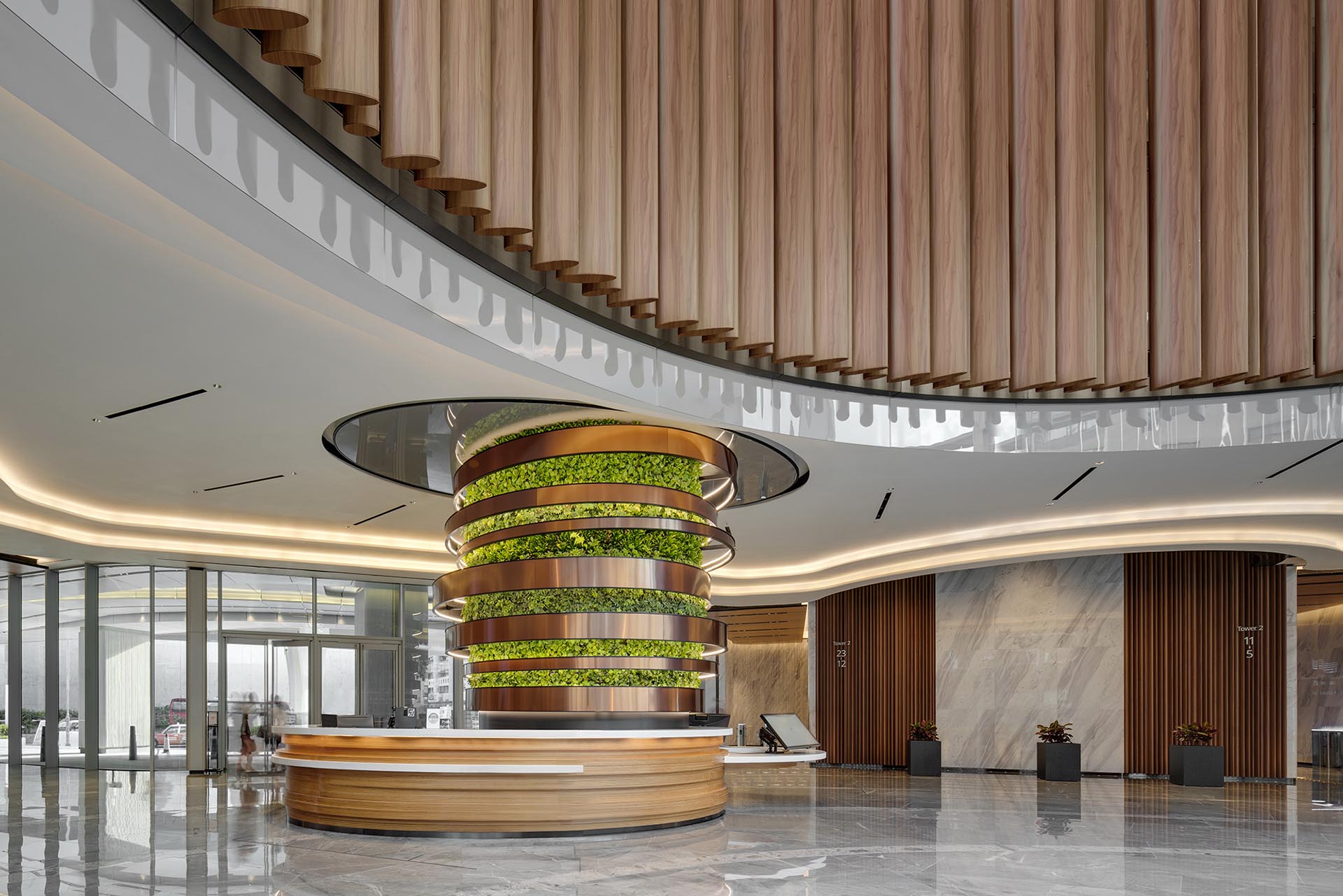 A column of plants adds a green touch to an building interior.