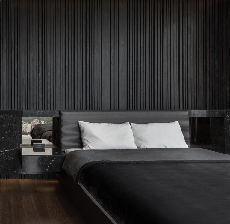 This Bedroom's Textured Accent Wall Was Made With A Variety Of Black Stained Vertical Wood Slats