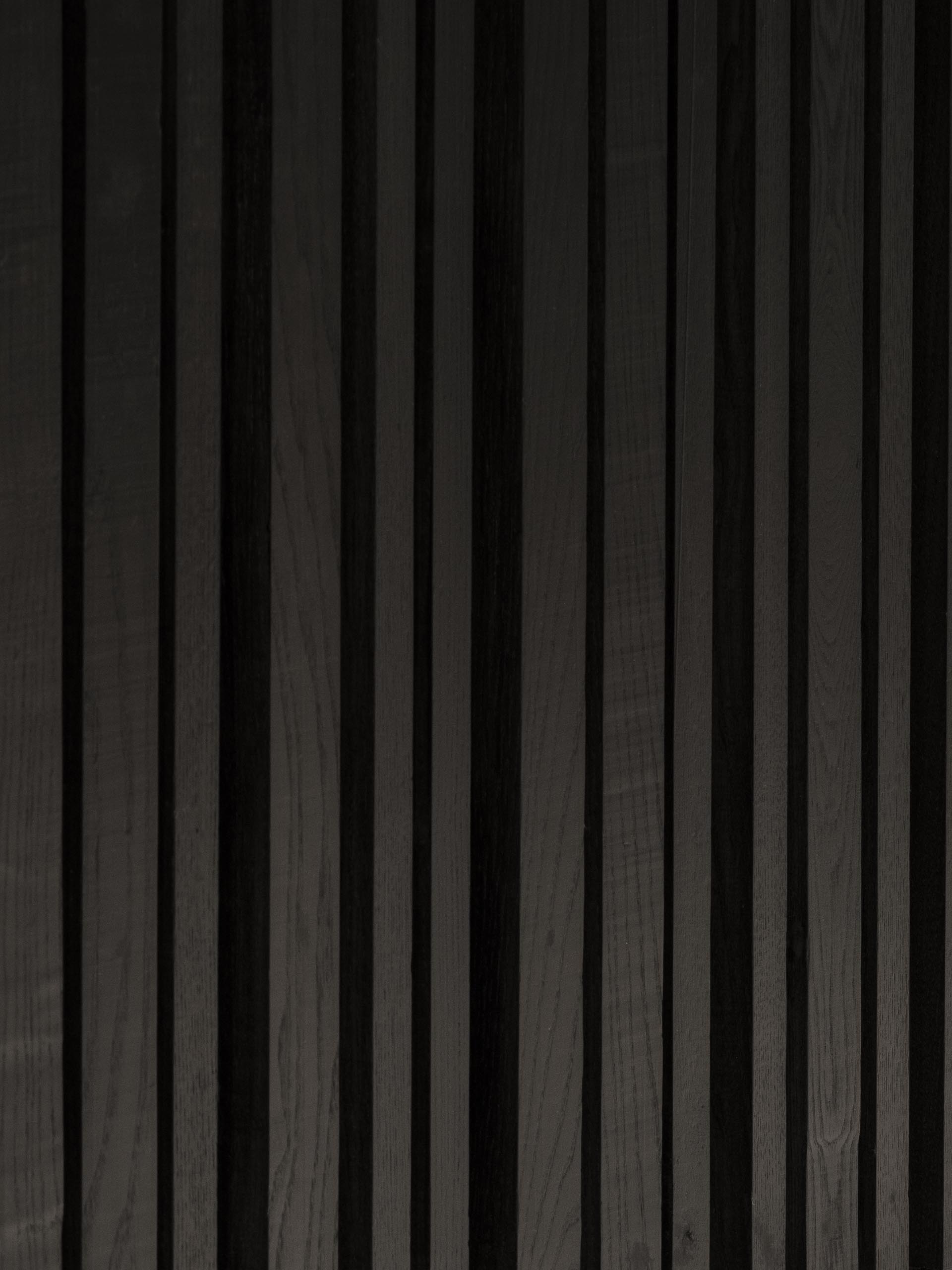 A matte black stained wood accent wall.