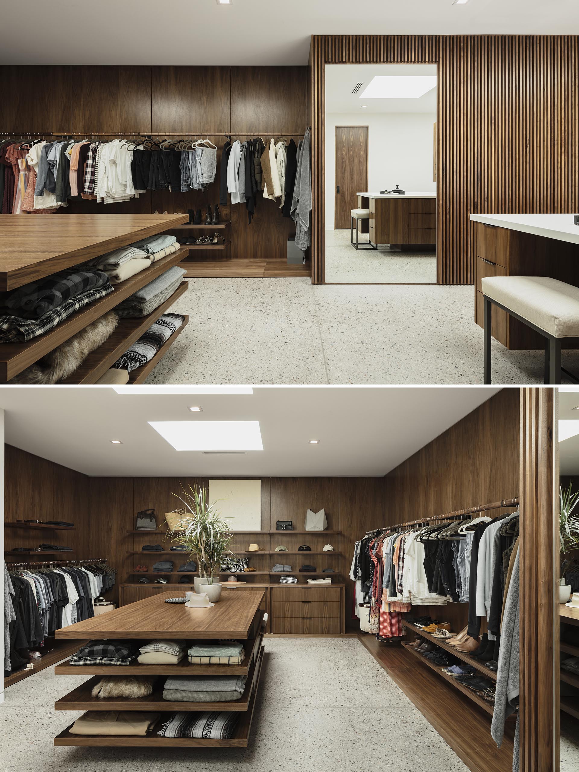 A retail inspired walk-in closet with a central table providing extra storage.