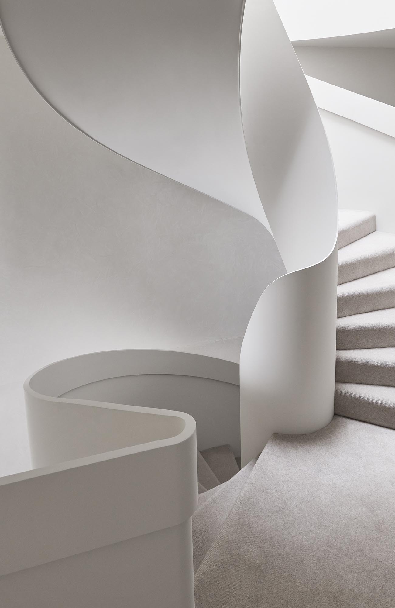 White spiral stairs in a modern house.
