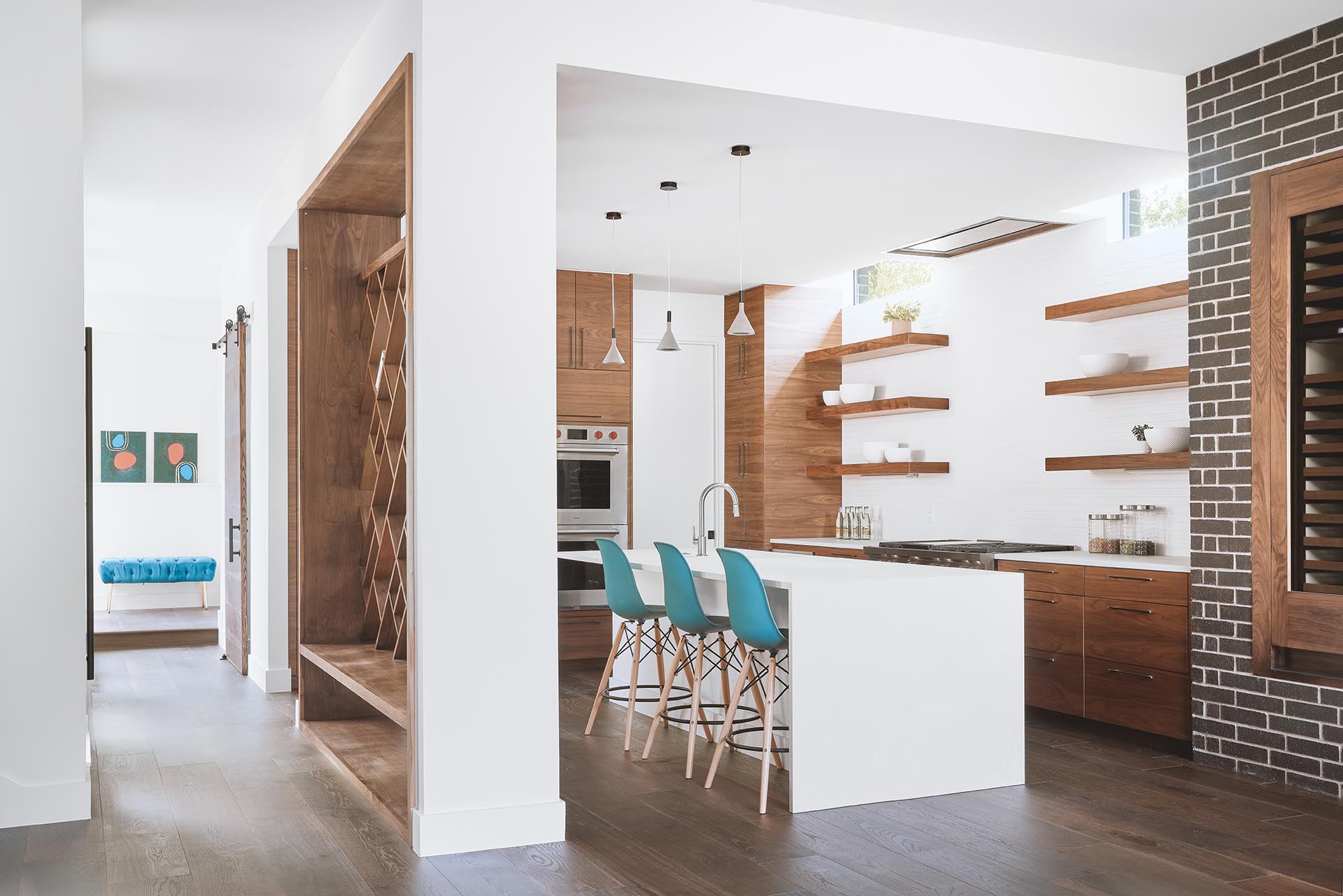 A custom entryway bench that has see-through diagonal wood shelving above.