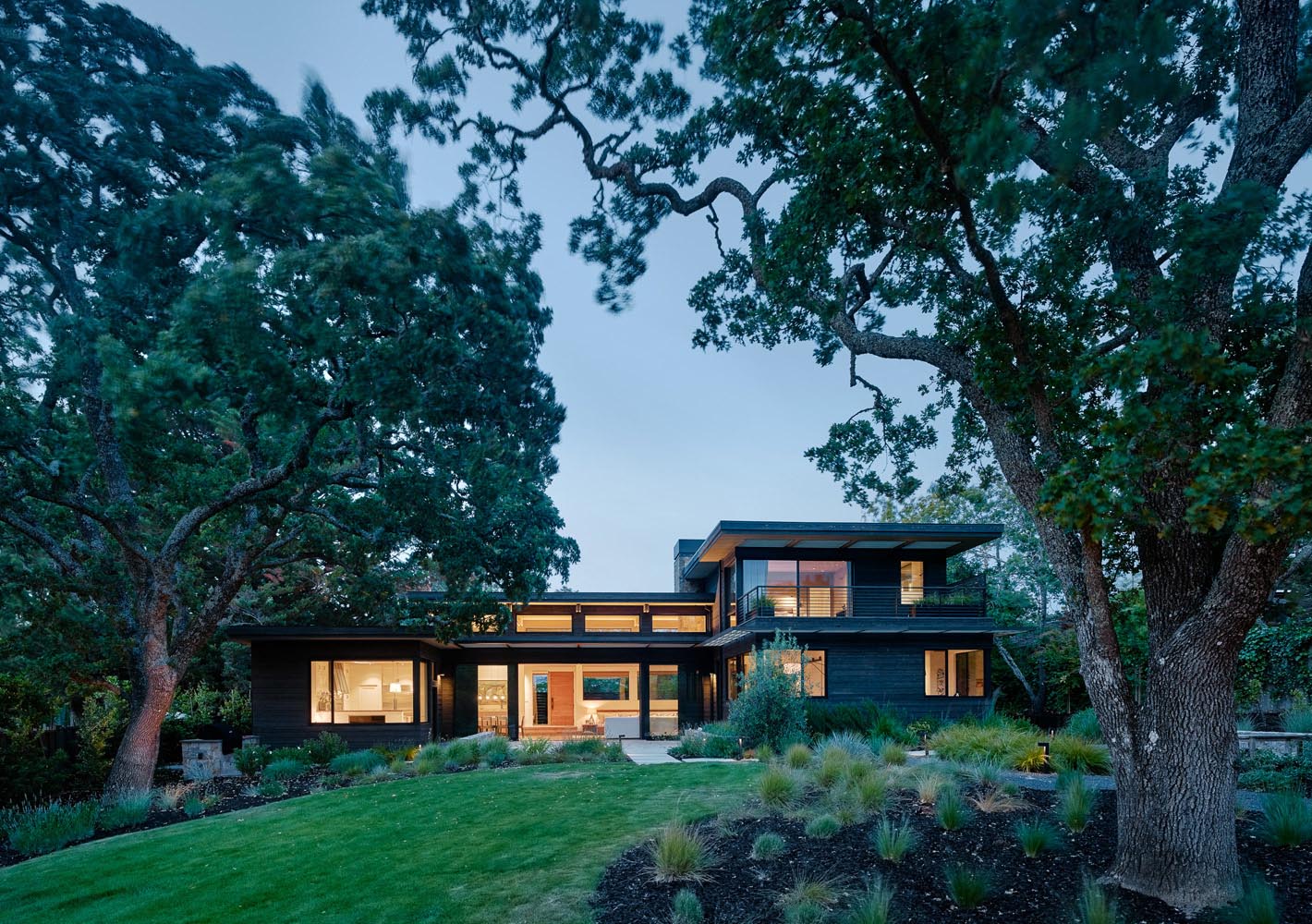 A modern house exterior with black-stained cedar siding.