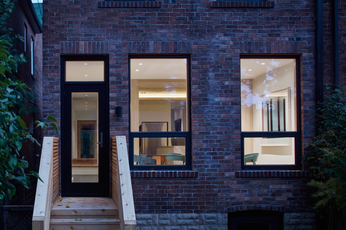 A brick house with black window frames and a modern interior.