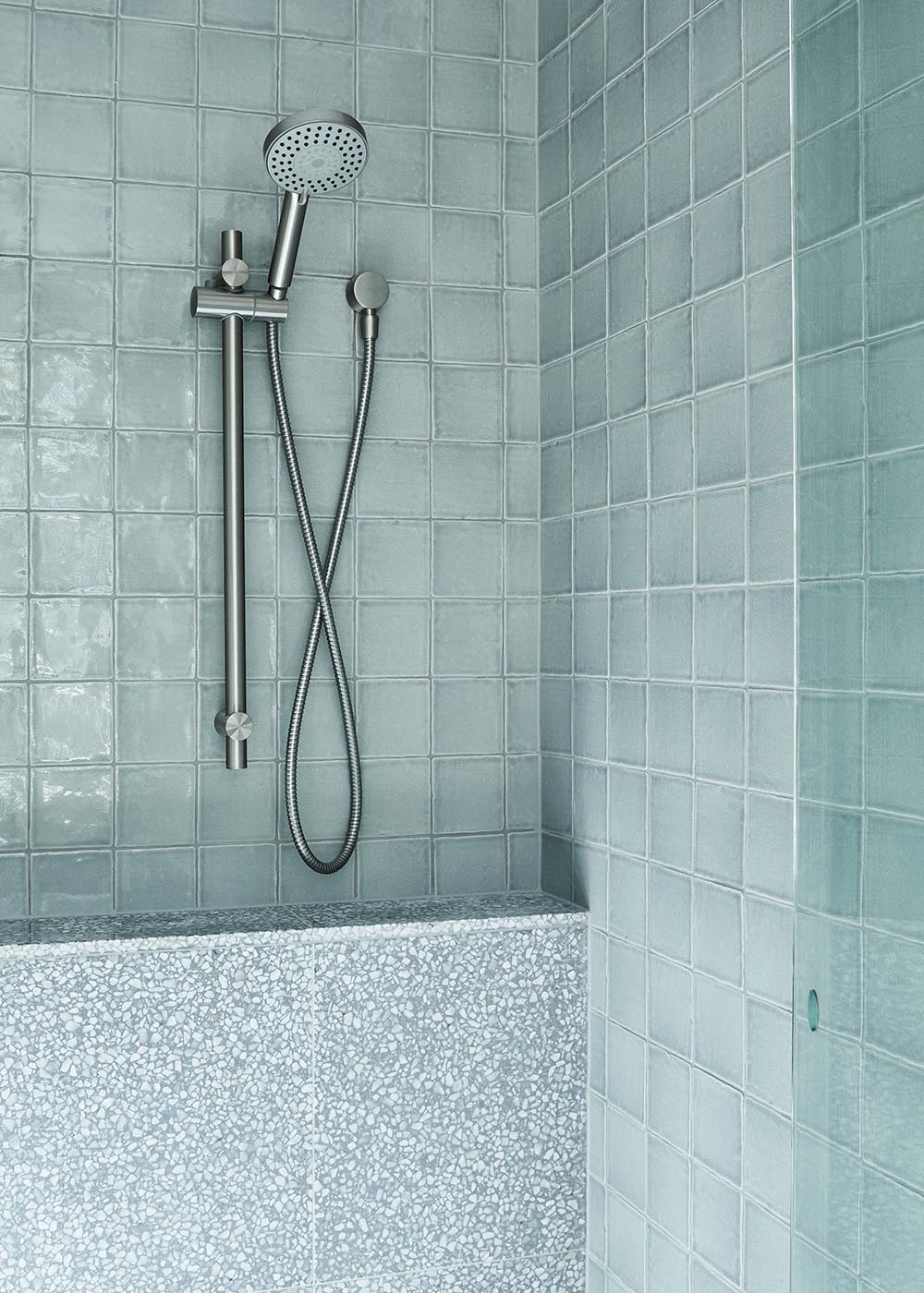 Soft blue handmade tiles employed in the bathroom offer a sense of restrained luxury.