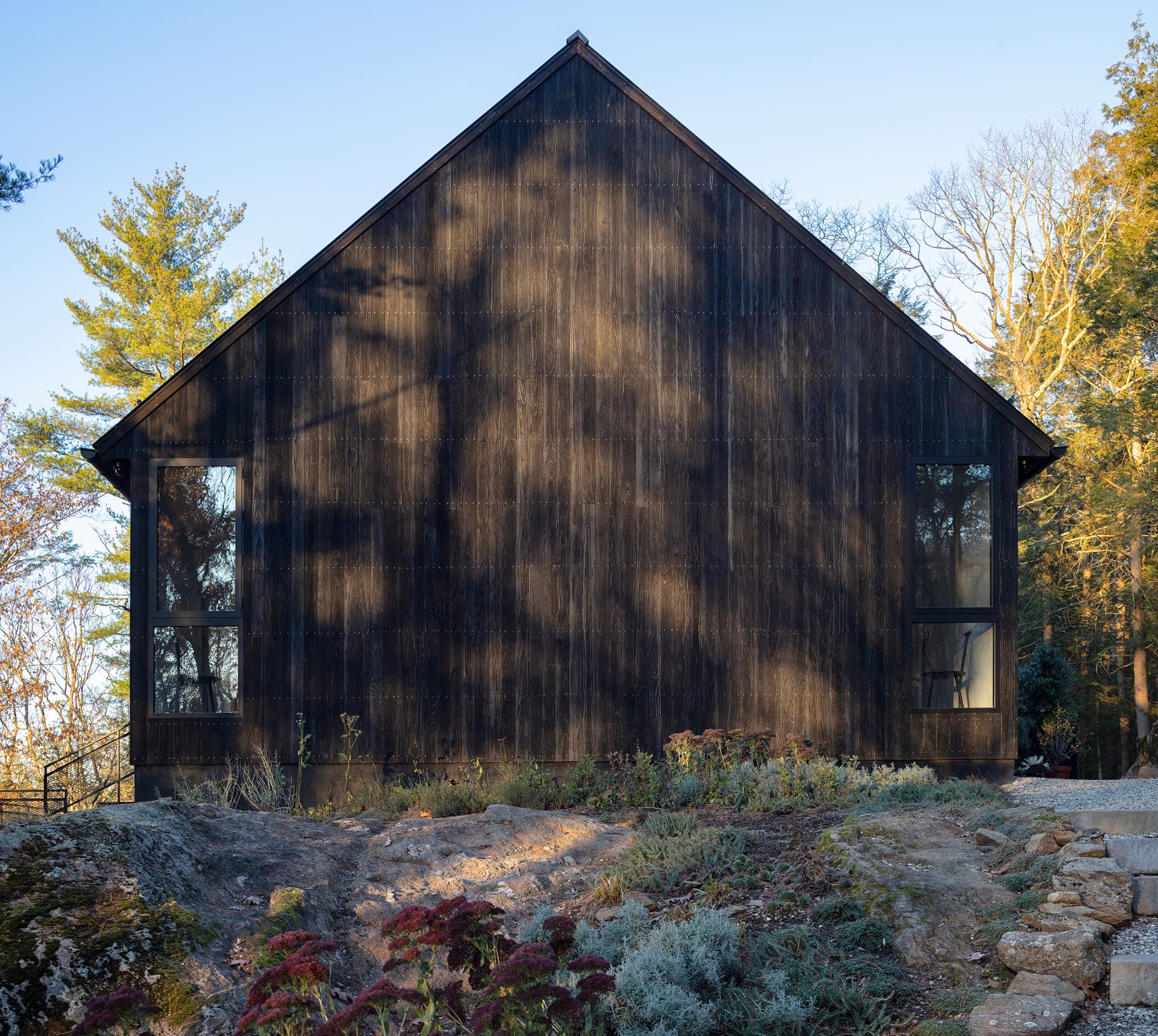 A modern black house with Shou Sugi Ban exterior siding.