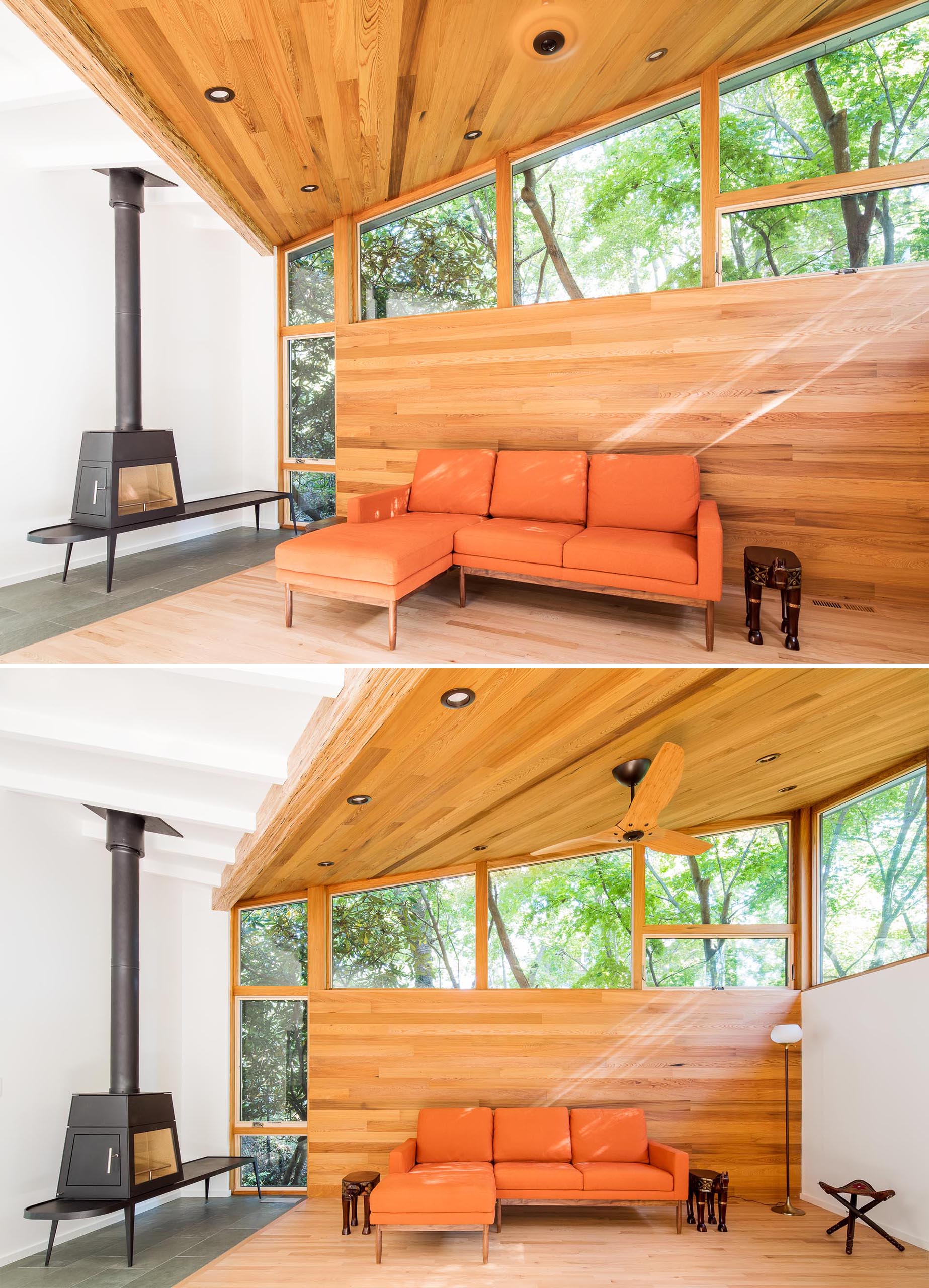 A contemporary living room with a wood accent wall and ceiling, windows that follow the roof line, and a contrasting black fireplace.