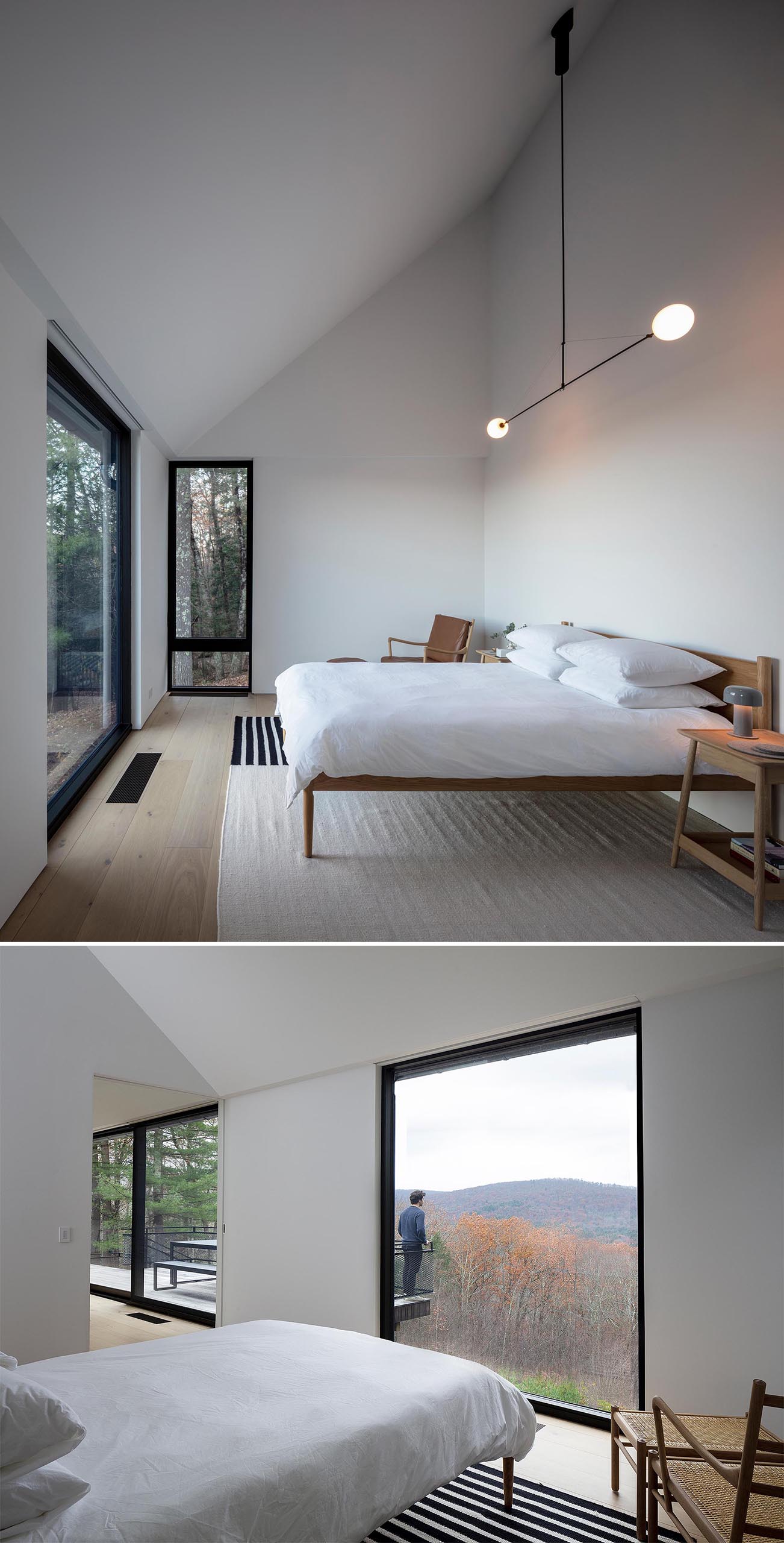 A minimalist master bedroom with a sloped ceiling, white walls, a large rug, and modern wood furniture.