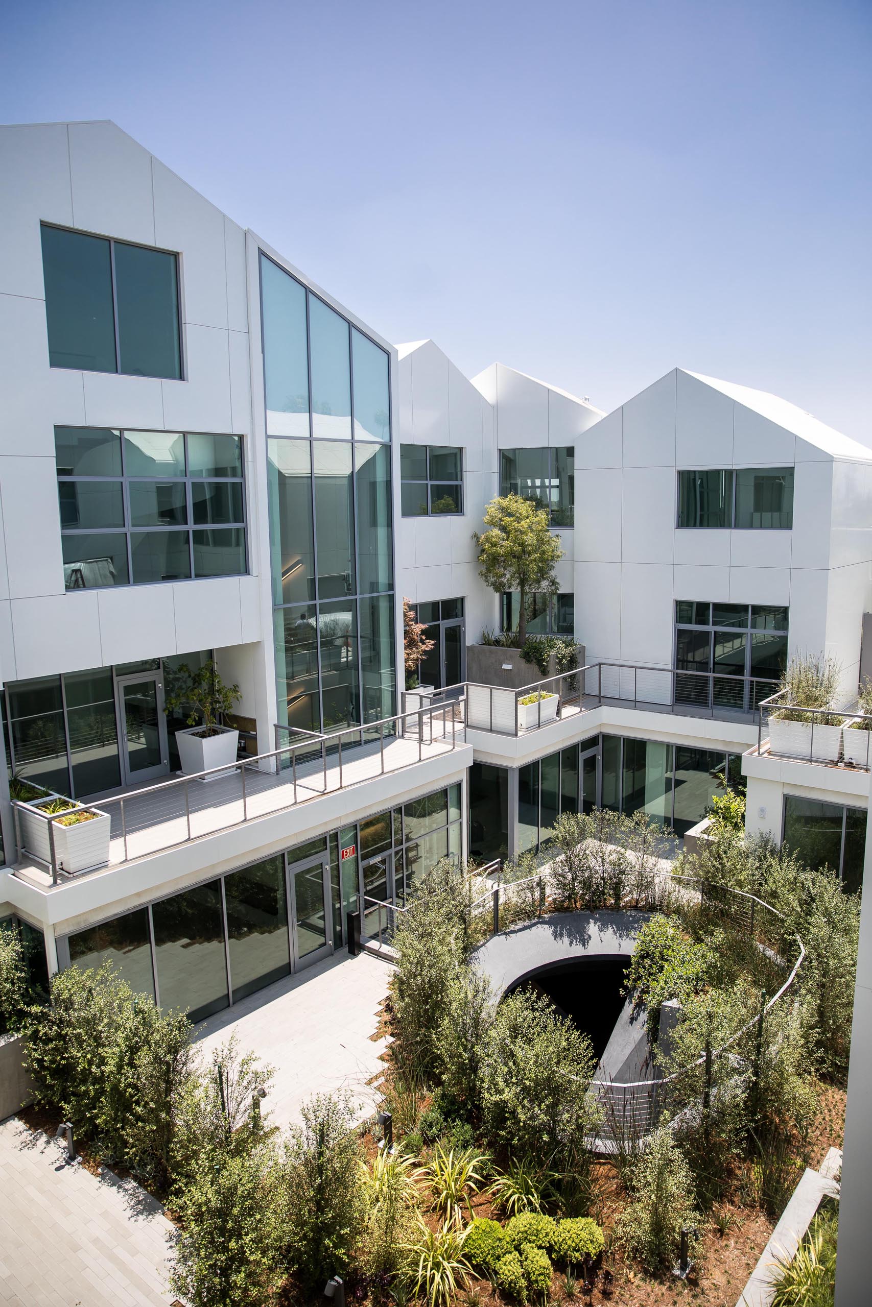 A modern residential building with terraces and gardens.