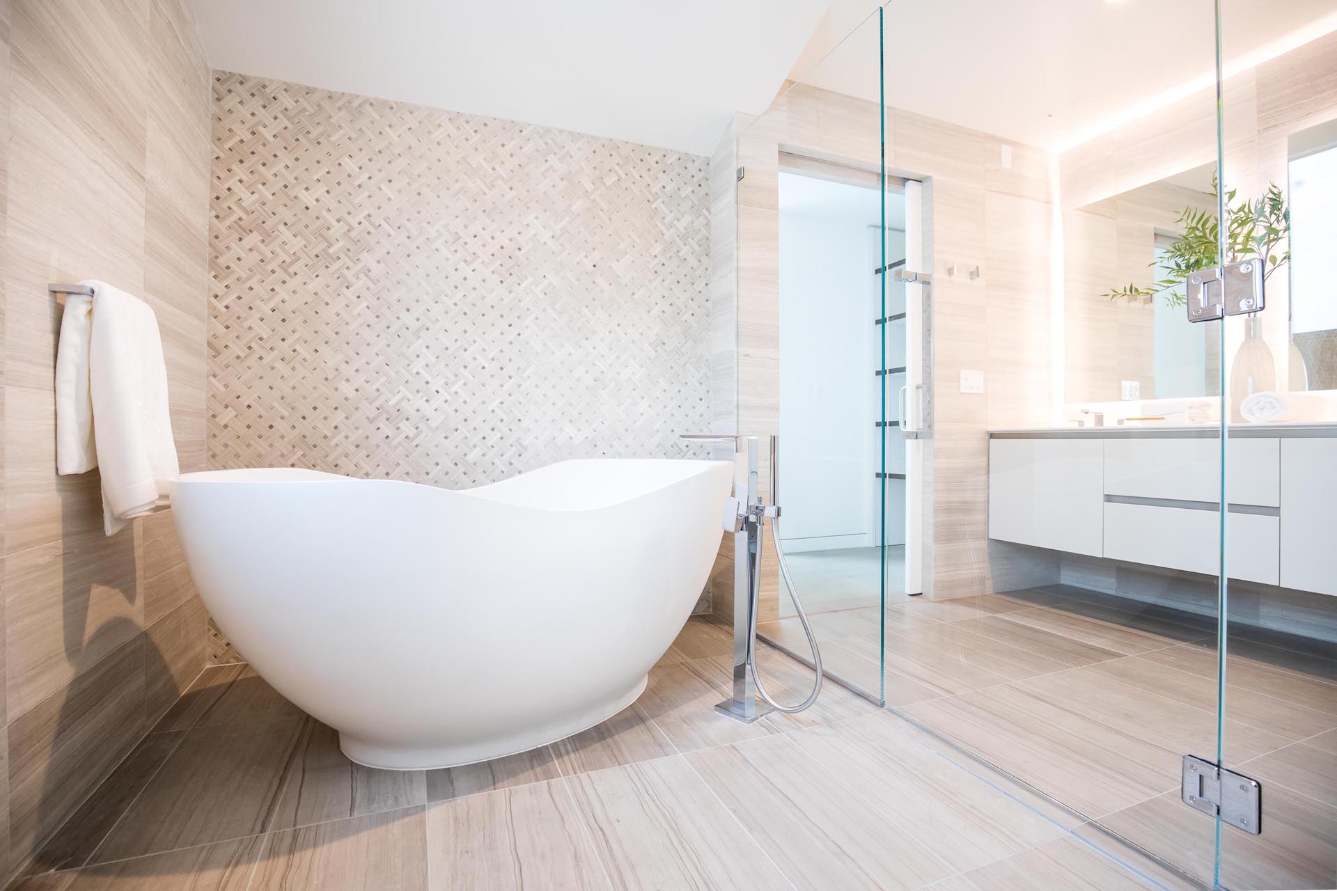A modern bathroom with a neutral color palette and freestanding bathtub.