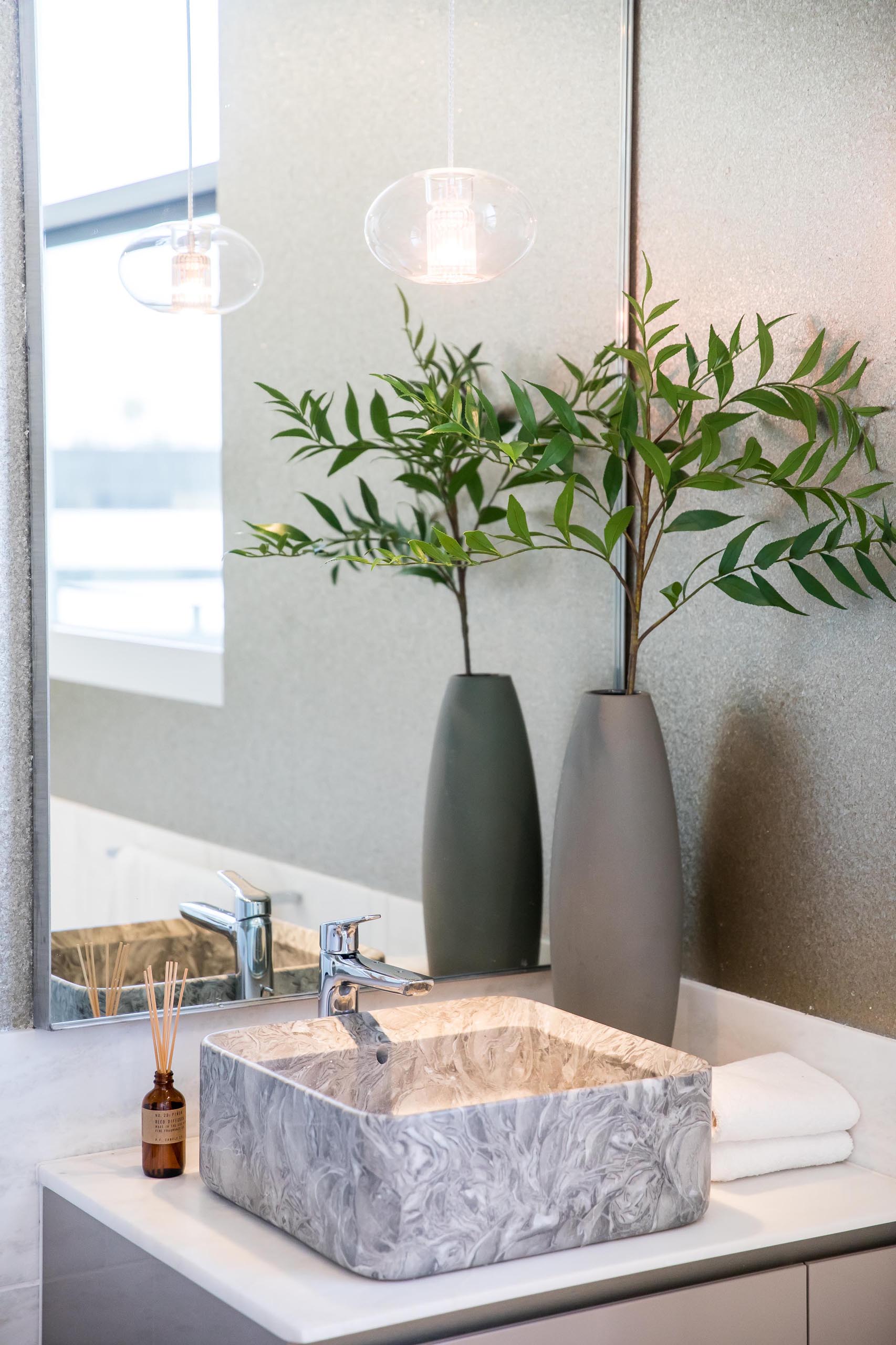 A modern bathroom with a square vessel sink.