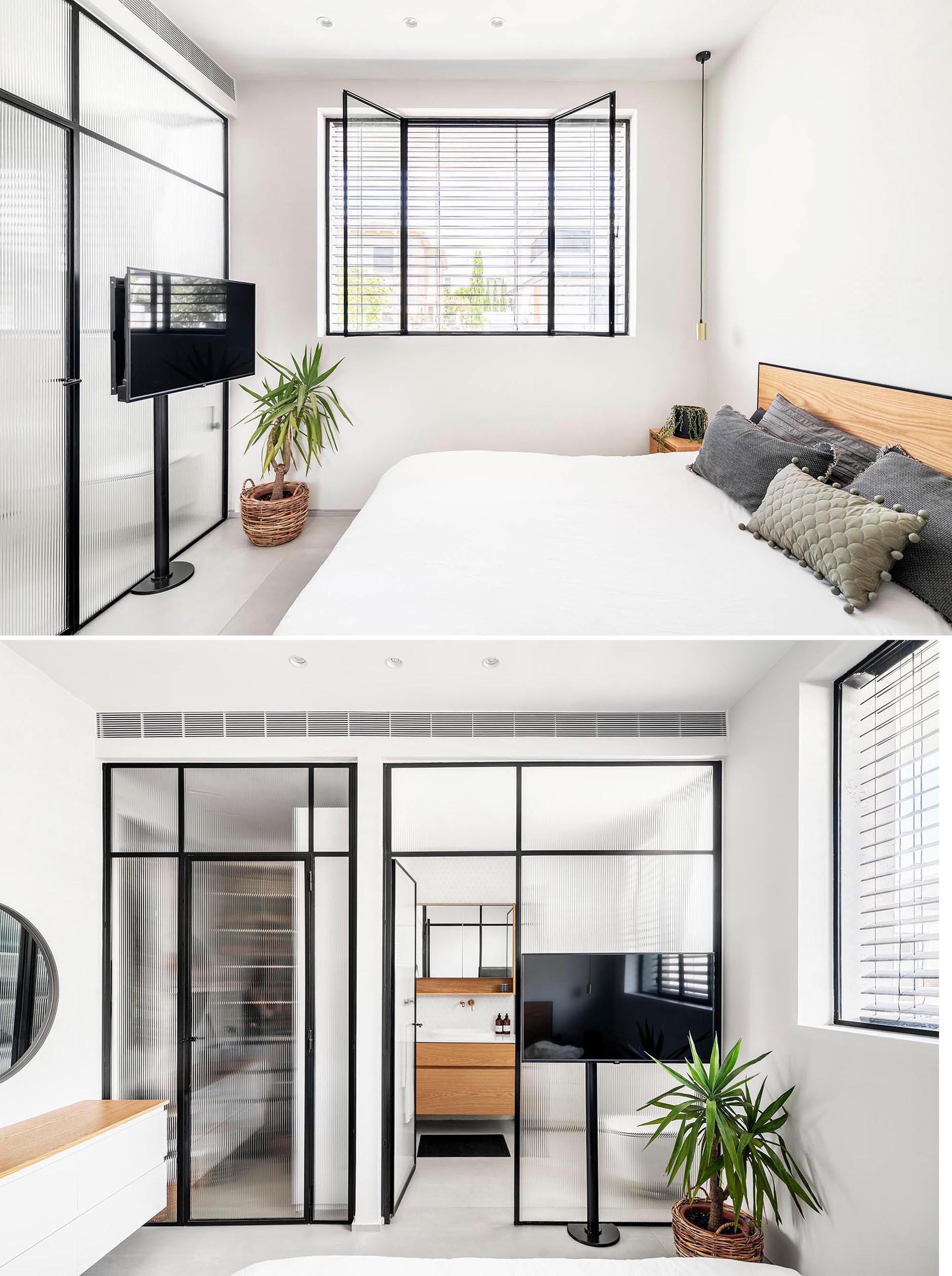 This modern master bedroom has an en-suite bathroom and built-in closet. Stripe-textured glass with iron frames separates these areas without obscuring the light.