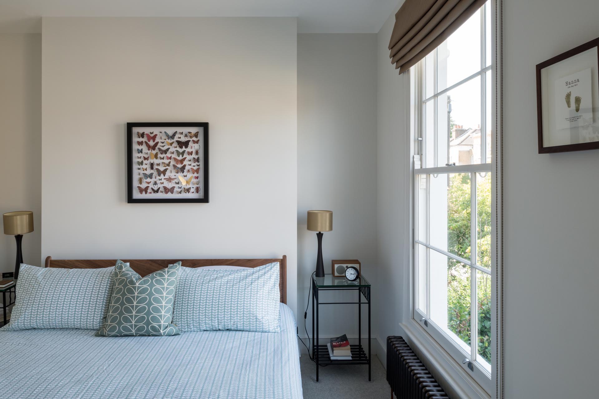 A modern master bedroom with a simple color theme and a walk-in closet.