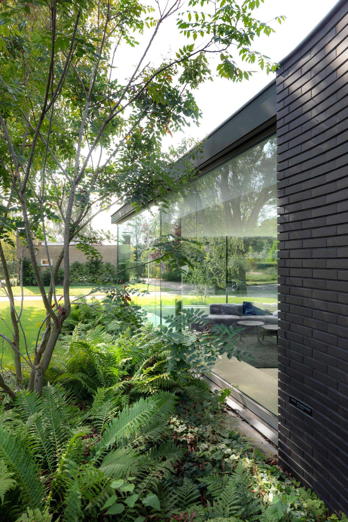 This Home Combines A Black Brick Exterior With Large Glass Walls For A Strong Contemporary Design