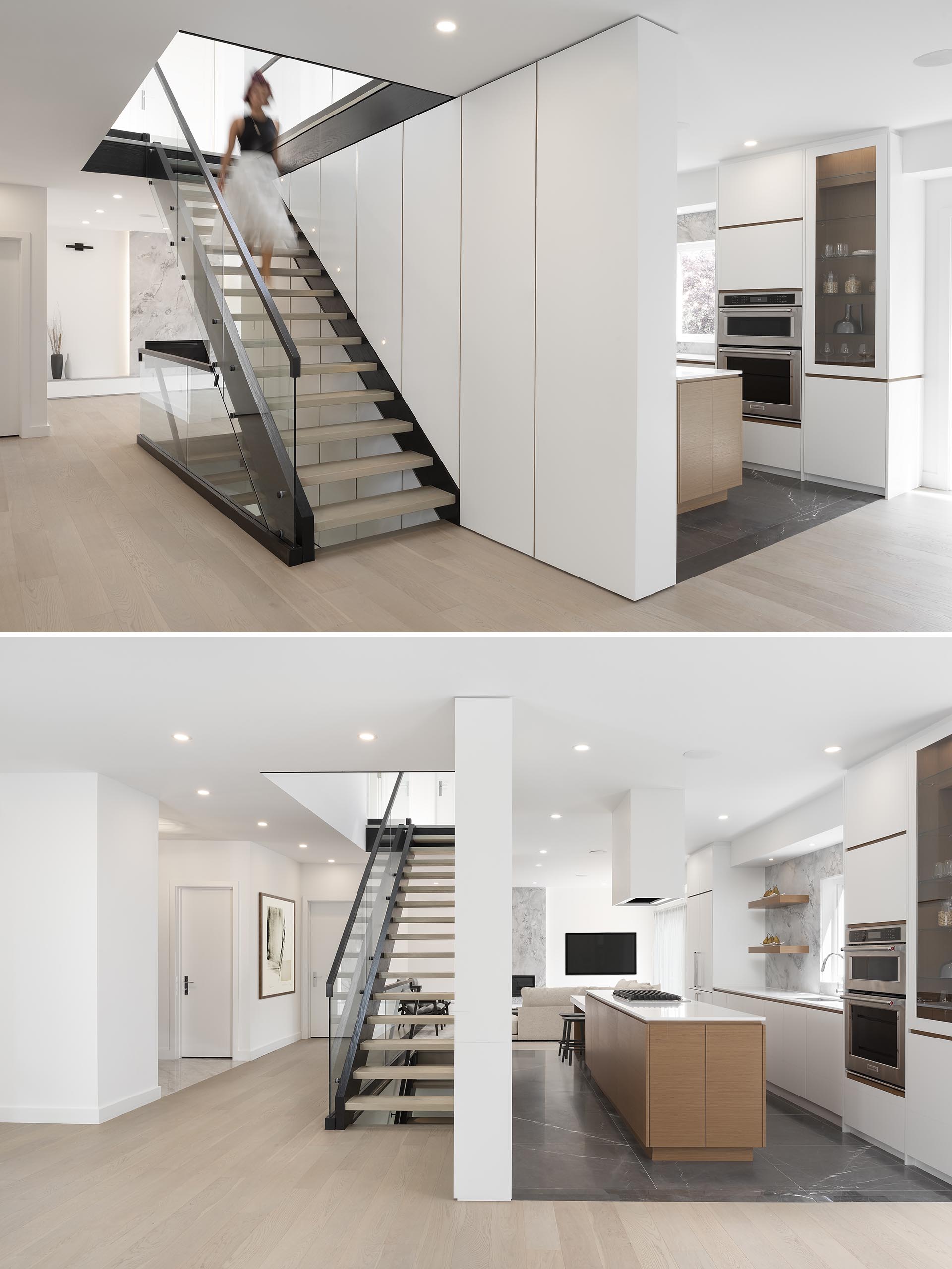 Modern stairs with a black steel frame, floating treads, modern consistent wall paneling, and a glass and steel handrail.