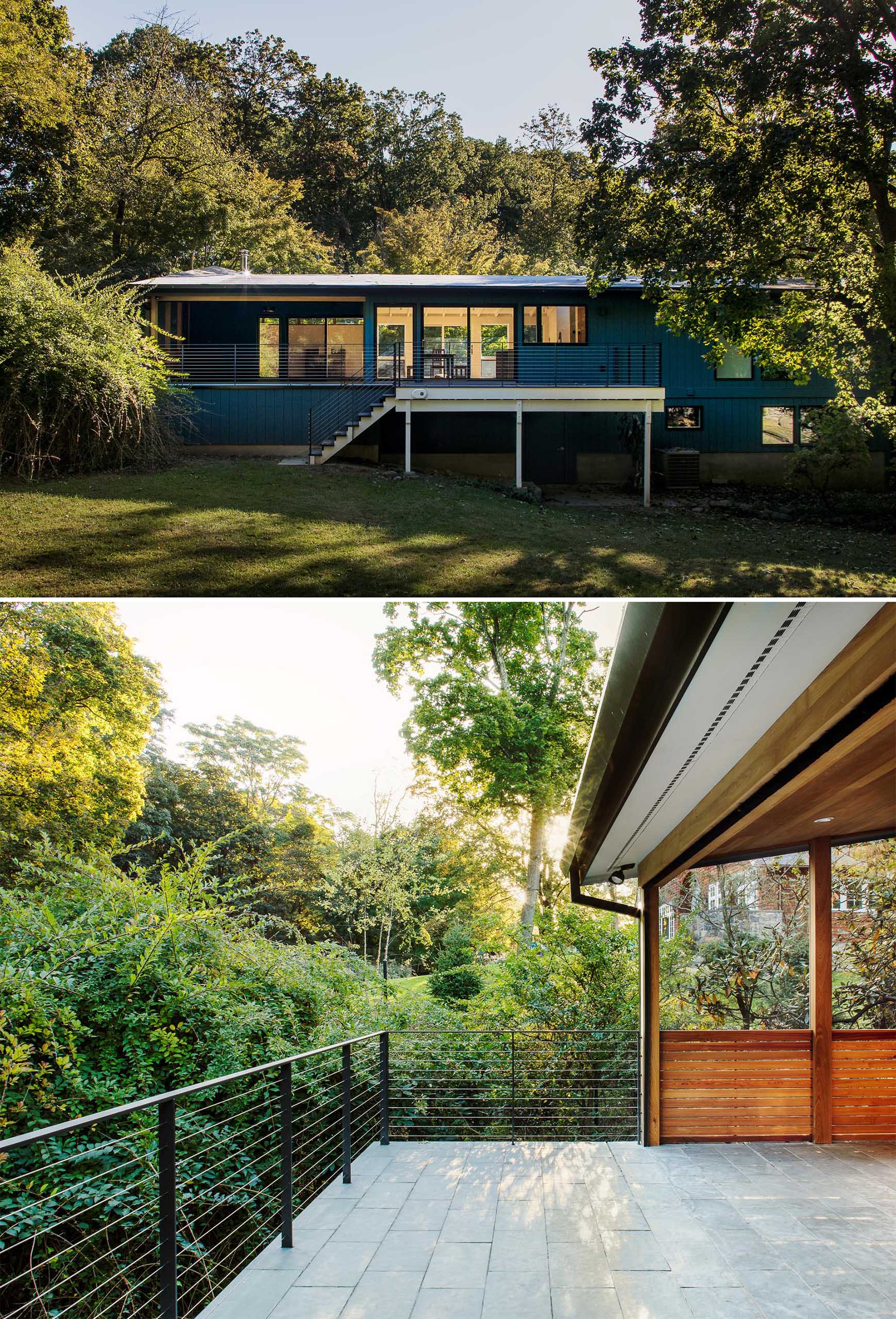 A blue house with a deck that leads to the backyard.