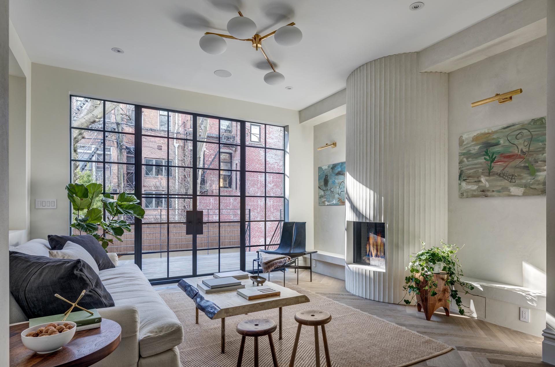 A modern living room with a fluted fireplace surround.