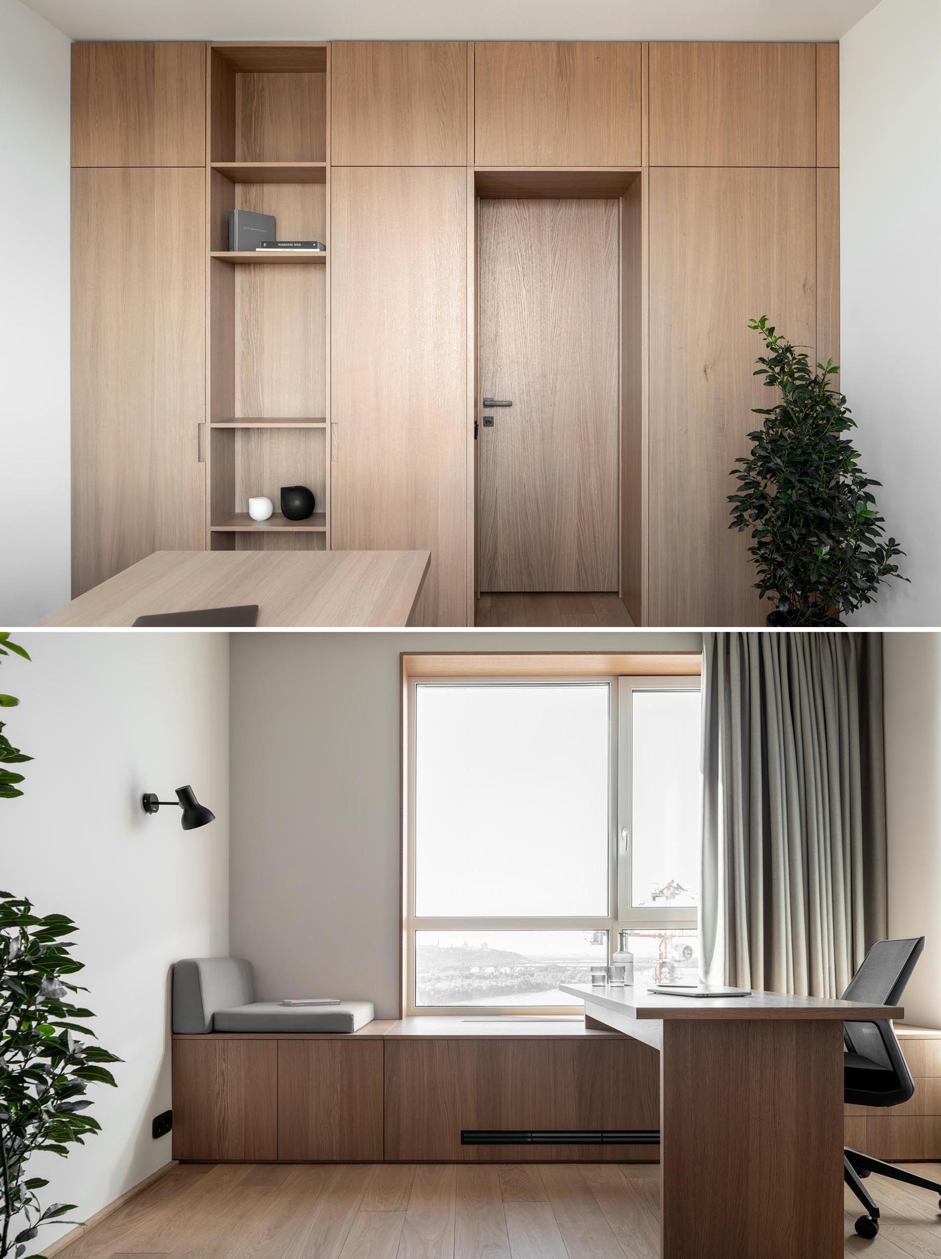 A home office with wood cabinets and shelving, a window bench, and a modern desk.