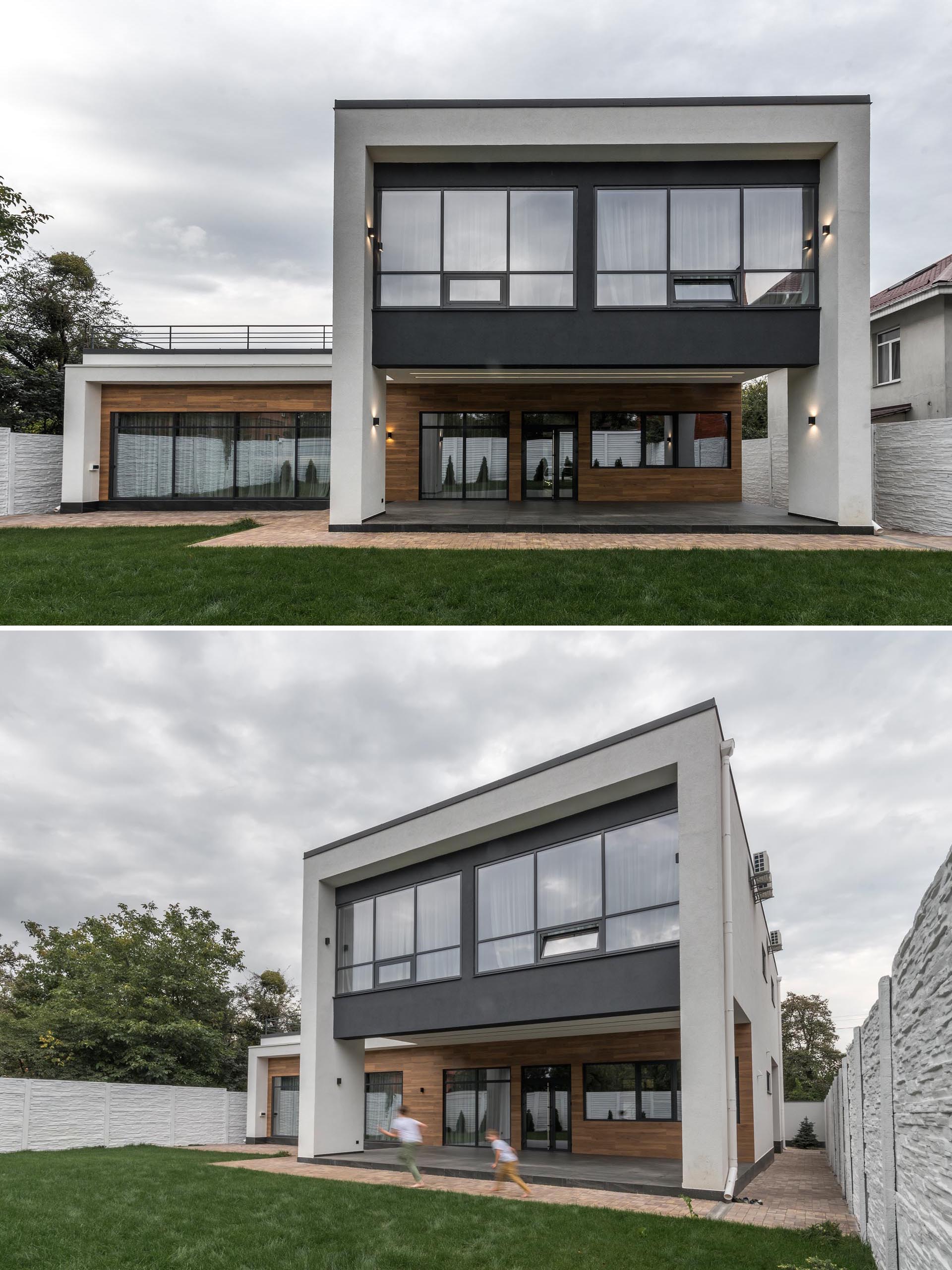 A modern home with wood-like tiles and matte black accentson the exterior.