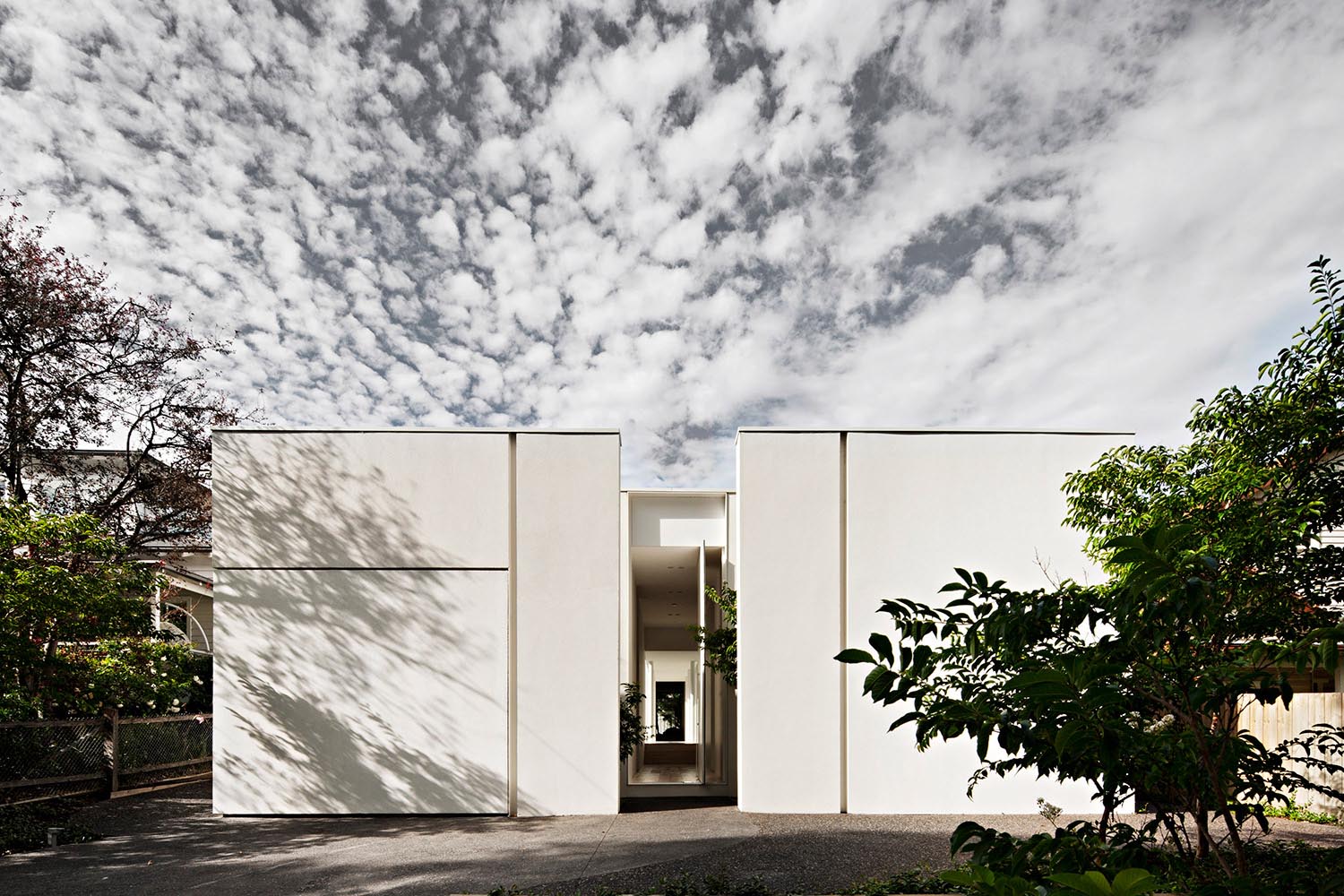 A modern house with a white rendered exterior.