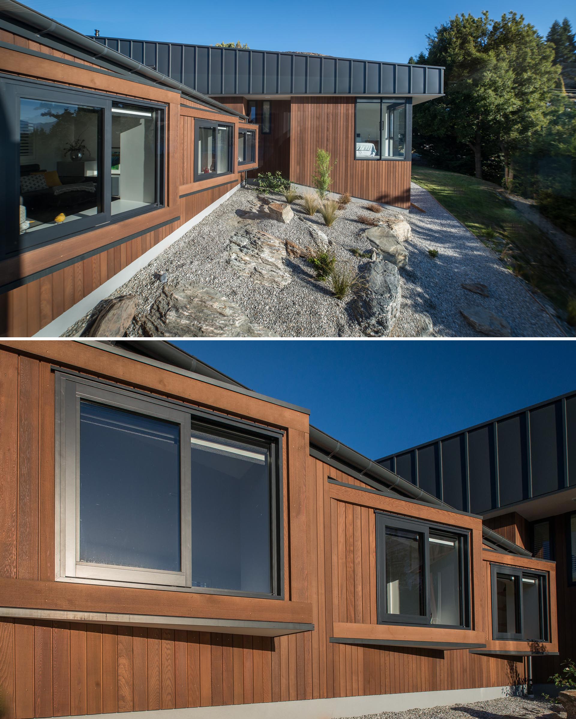 A modern house with wood and matte black metal siding, and angled windows.