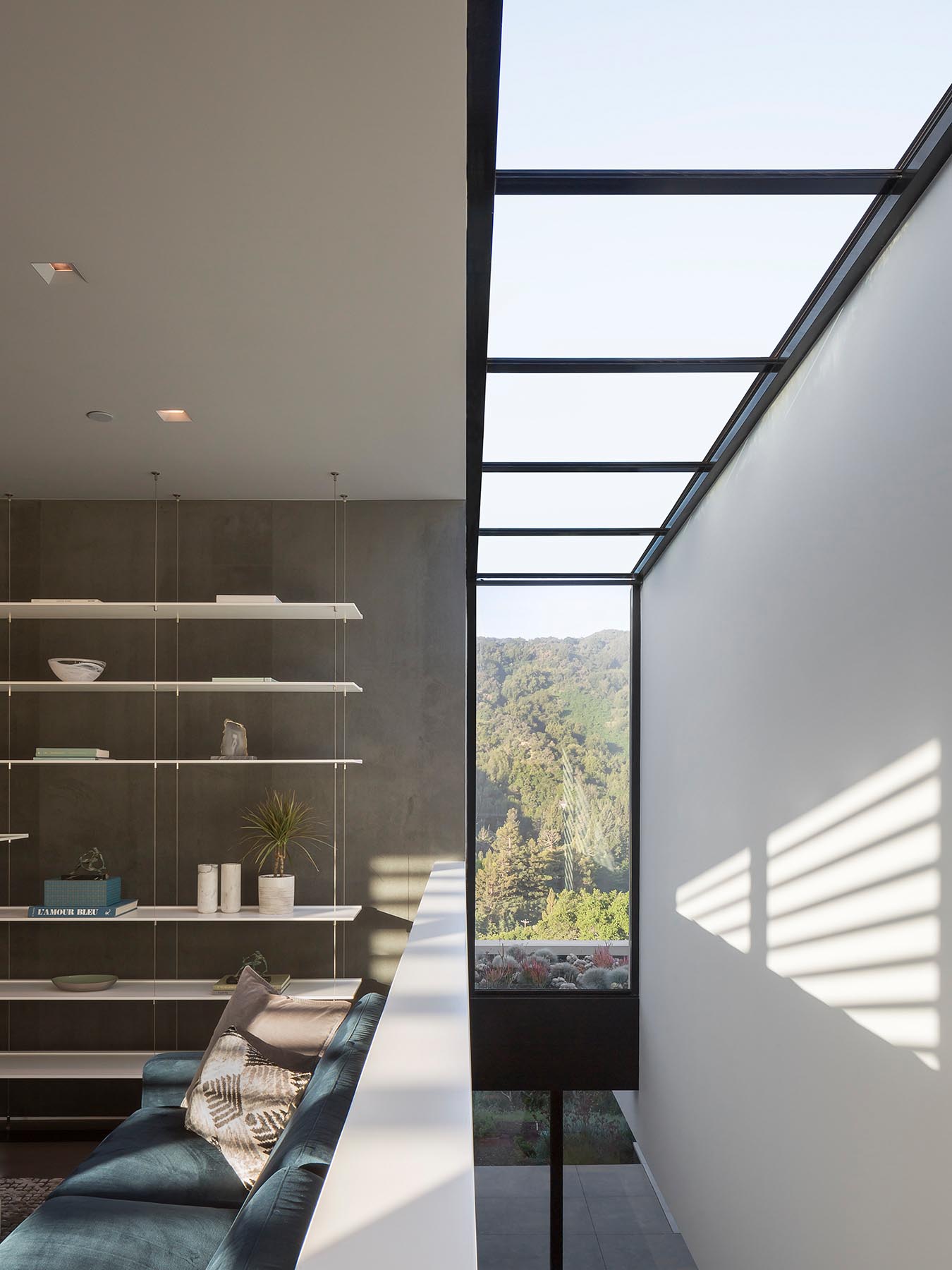 This modern house has a window that slices through a double height interior space.