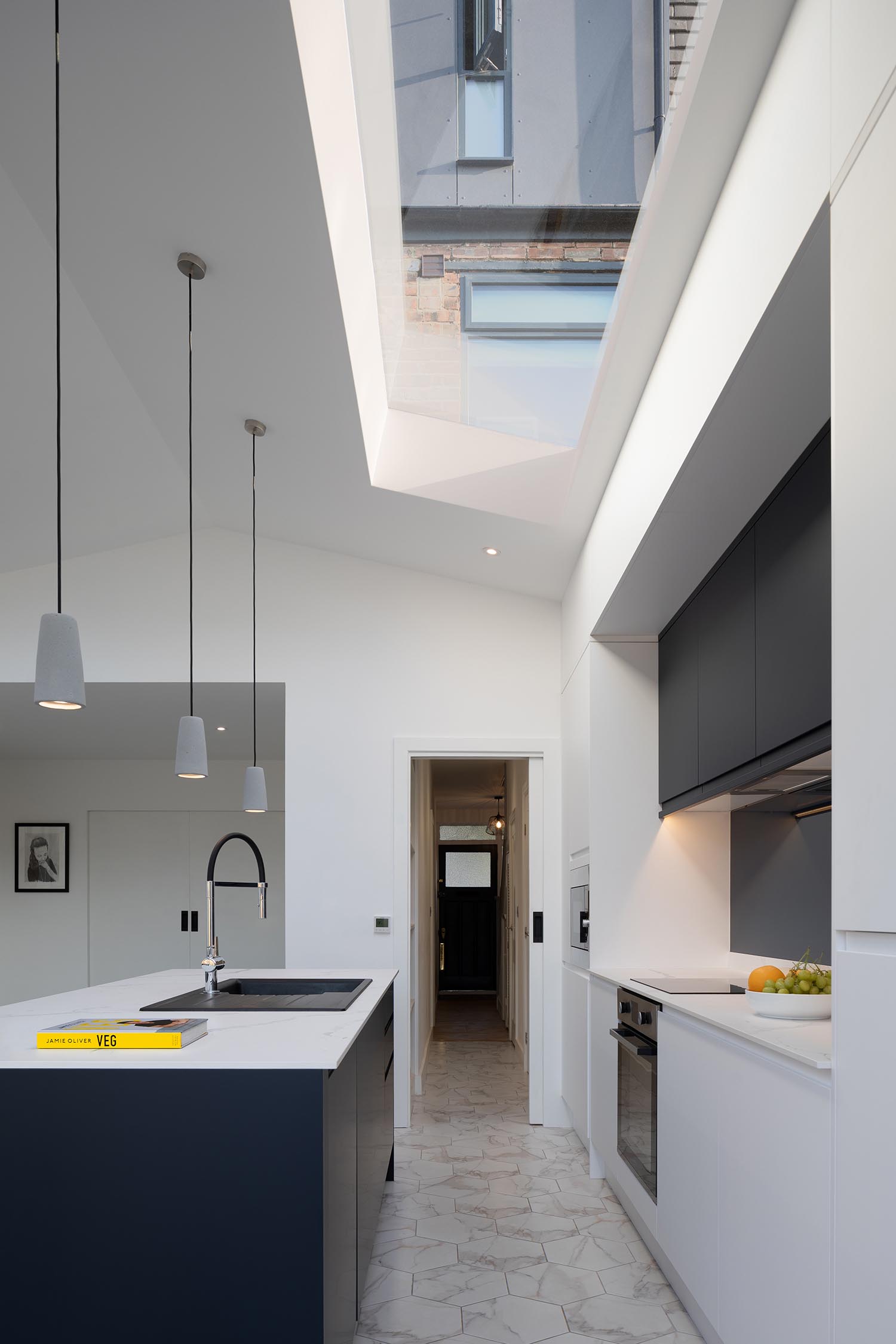 A modern kitchen with a skylight and pitched ceiling.