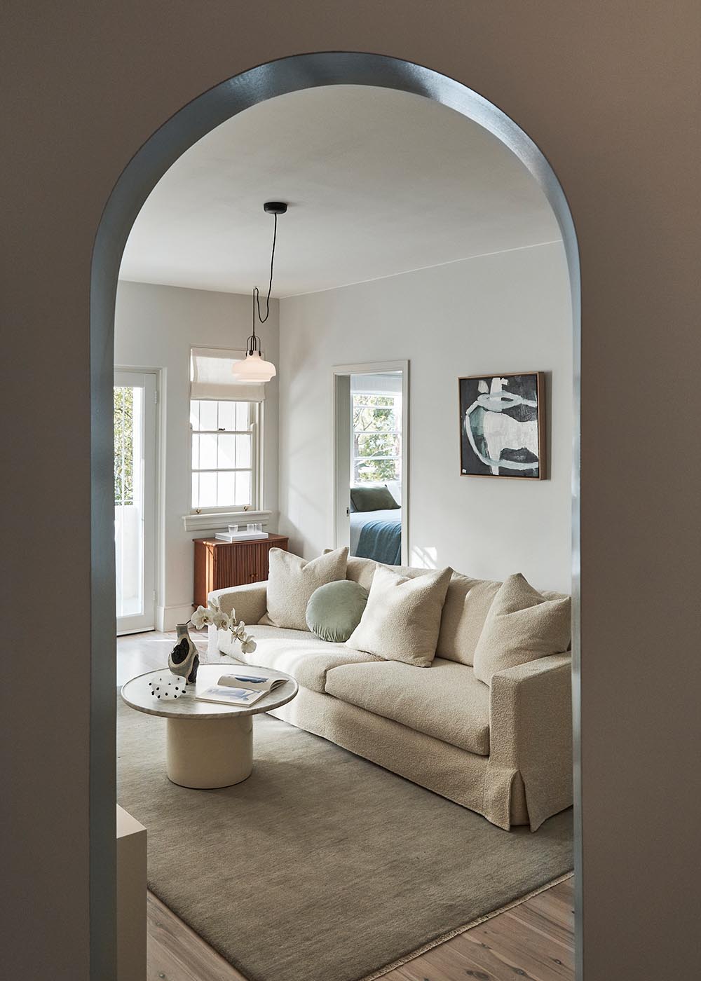 An arched door way and a light color palette.