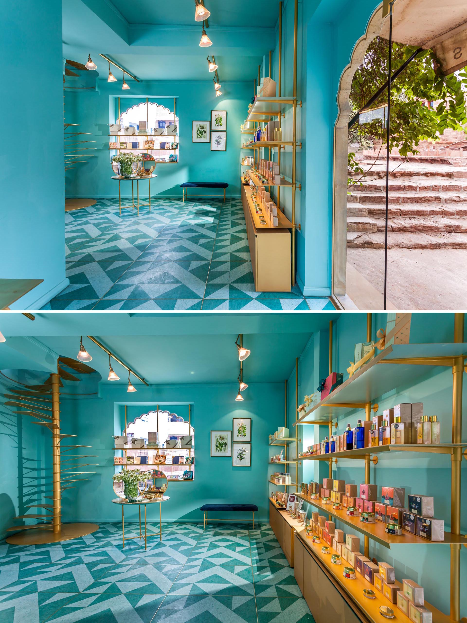 A modern retail store with teal blue walls, gold accents, and patterned lino flooring.