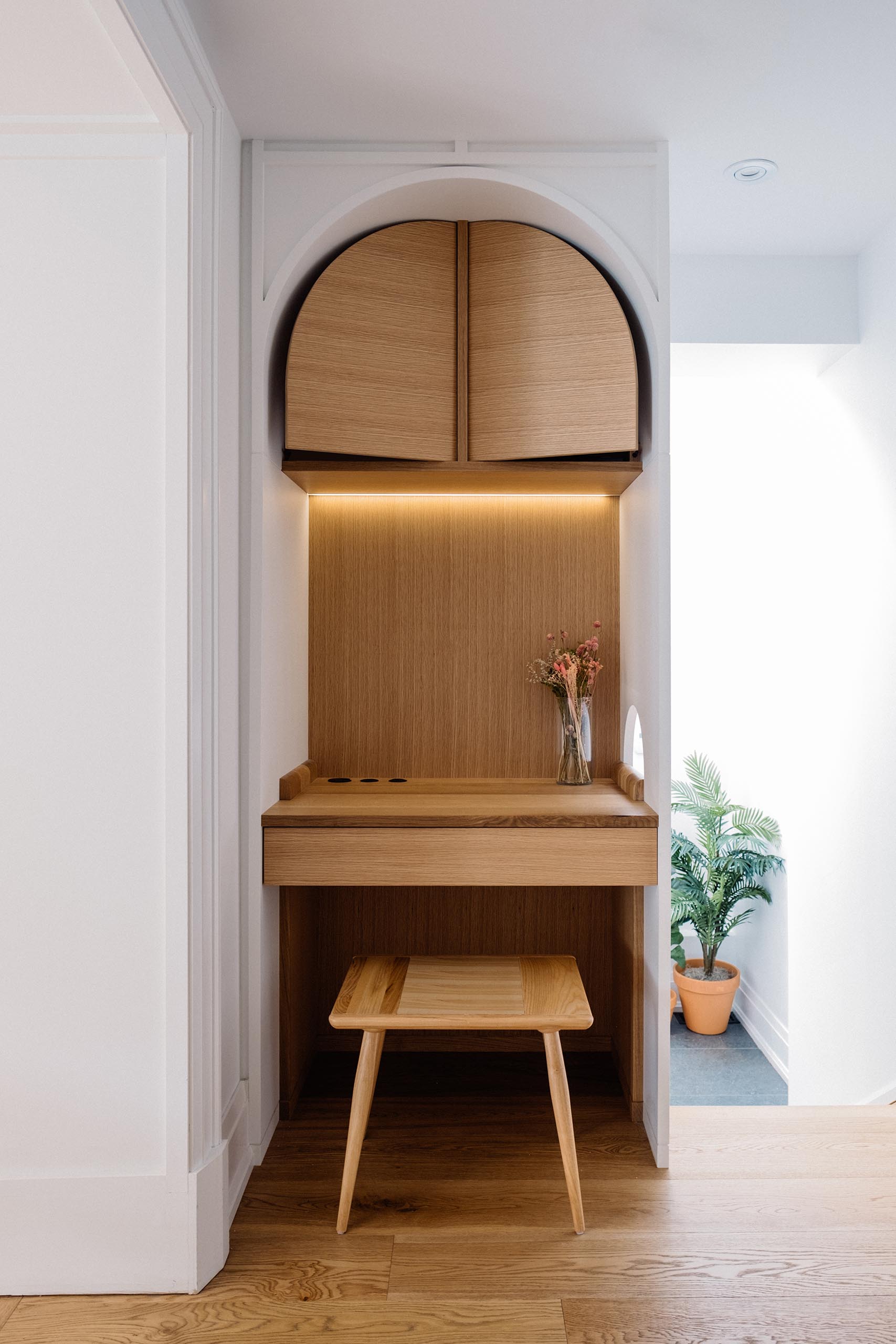 A small home office makes use of an awkward nook, and now includes storage and a desk.