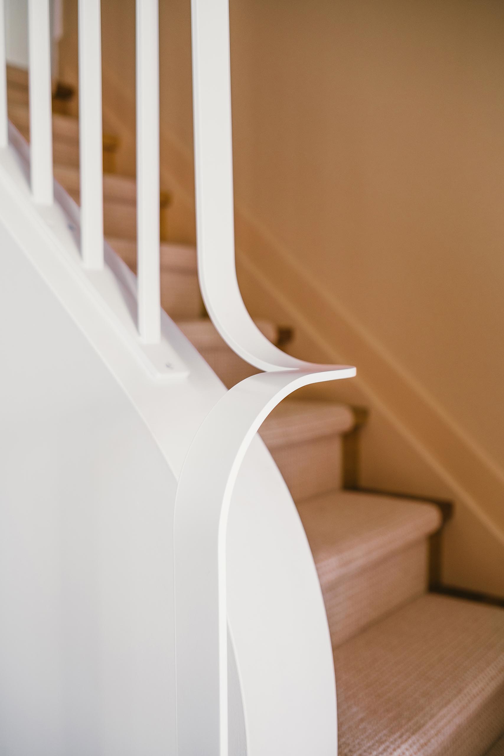 A curved and modern stair handrail.