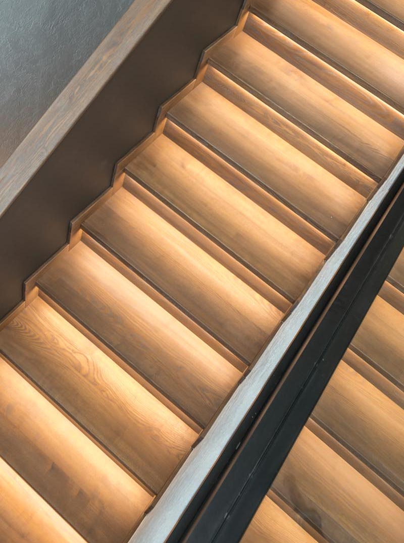 A wood staircase design with hidden lighting.