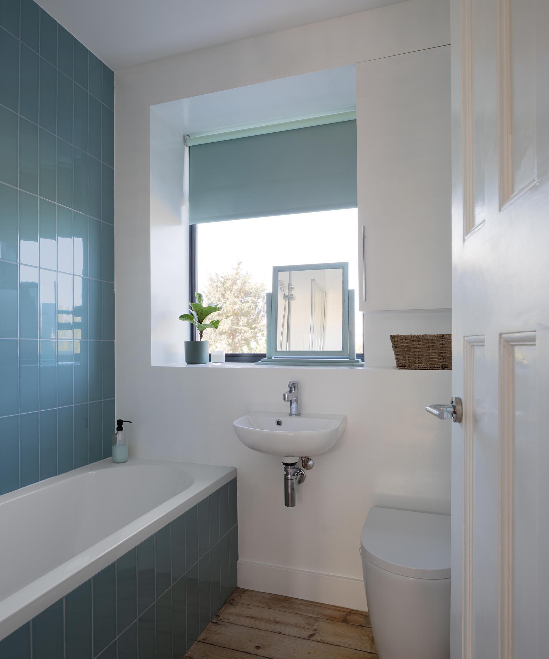 A bathroom with blue tiles.