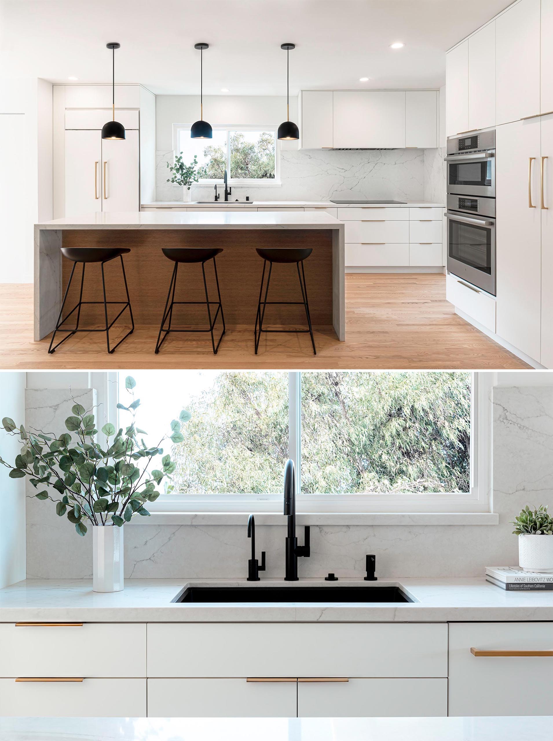 This open concept kitchen has white and wood cabinets and an island with a custom waterfall quartz countertop. 