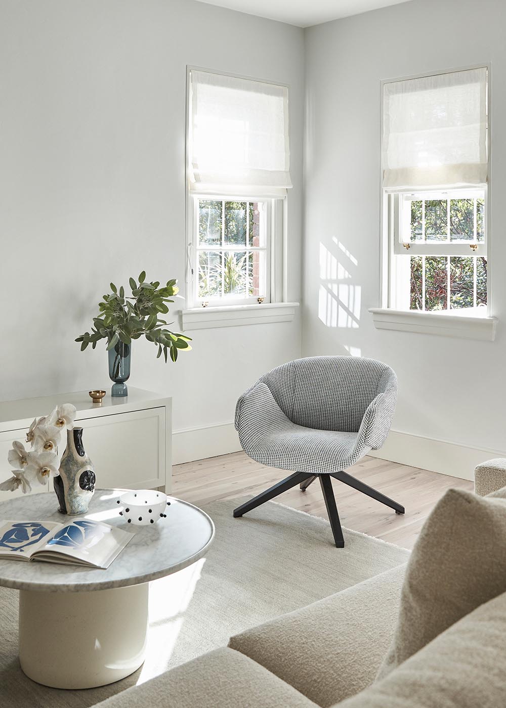 A living room with a light color theme and different textures.