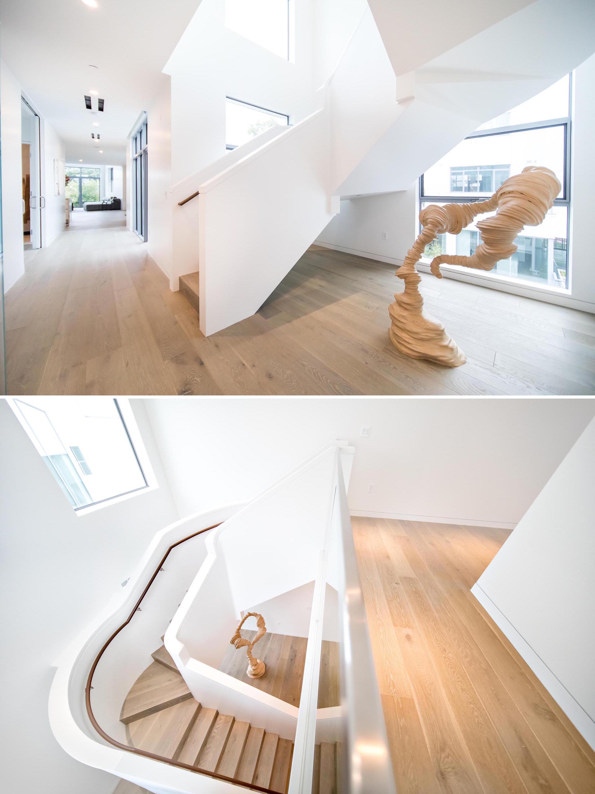 A modern white and wood sculptural staircase.