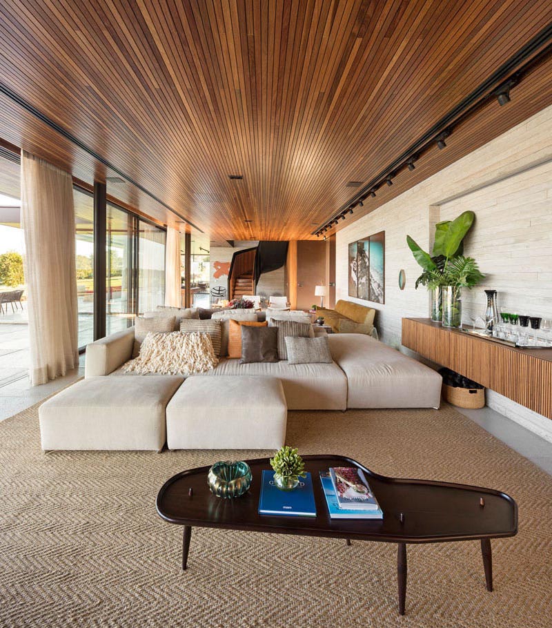 A modern living room with an expansive wood ceiling.