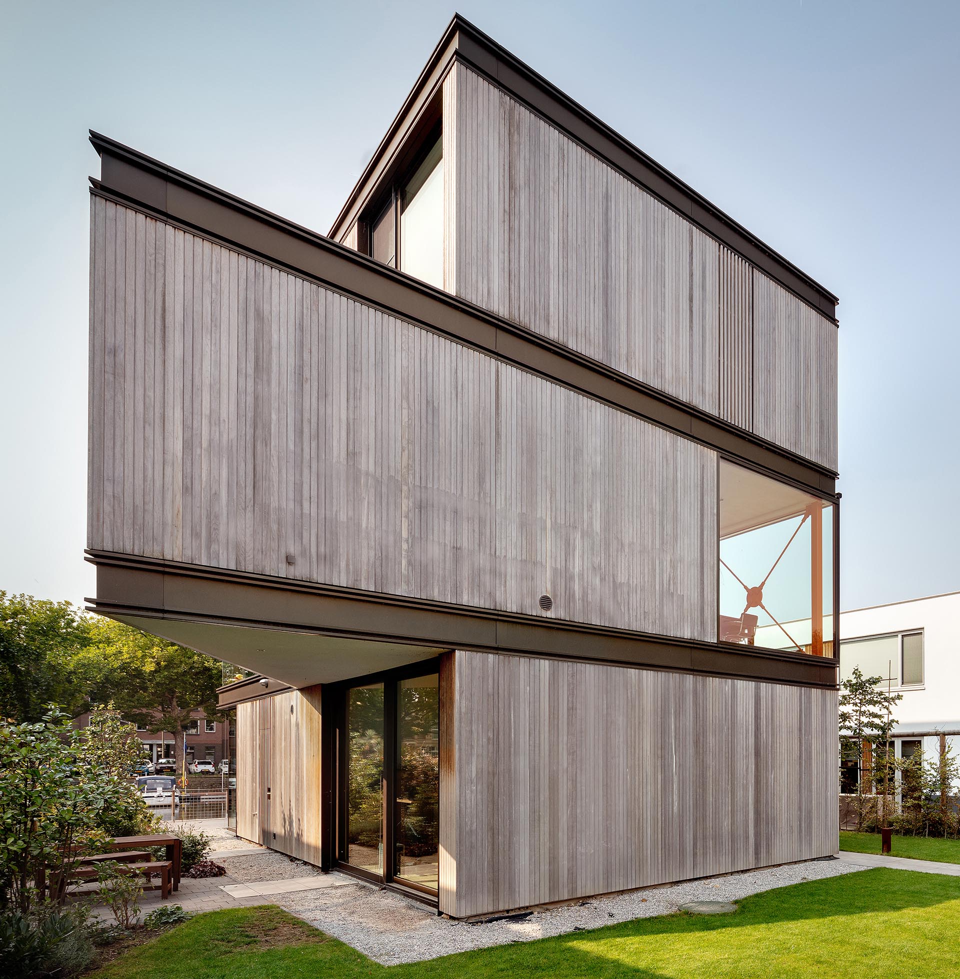 A modern house with an exterior of wood, metal, and glass.
