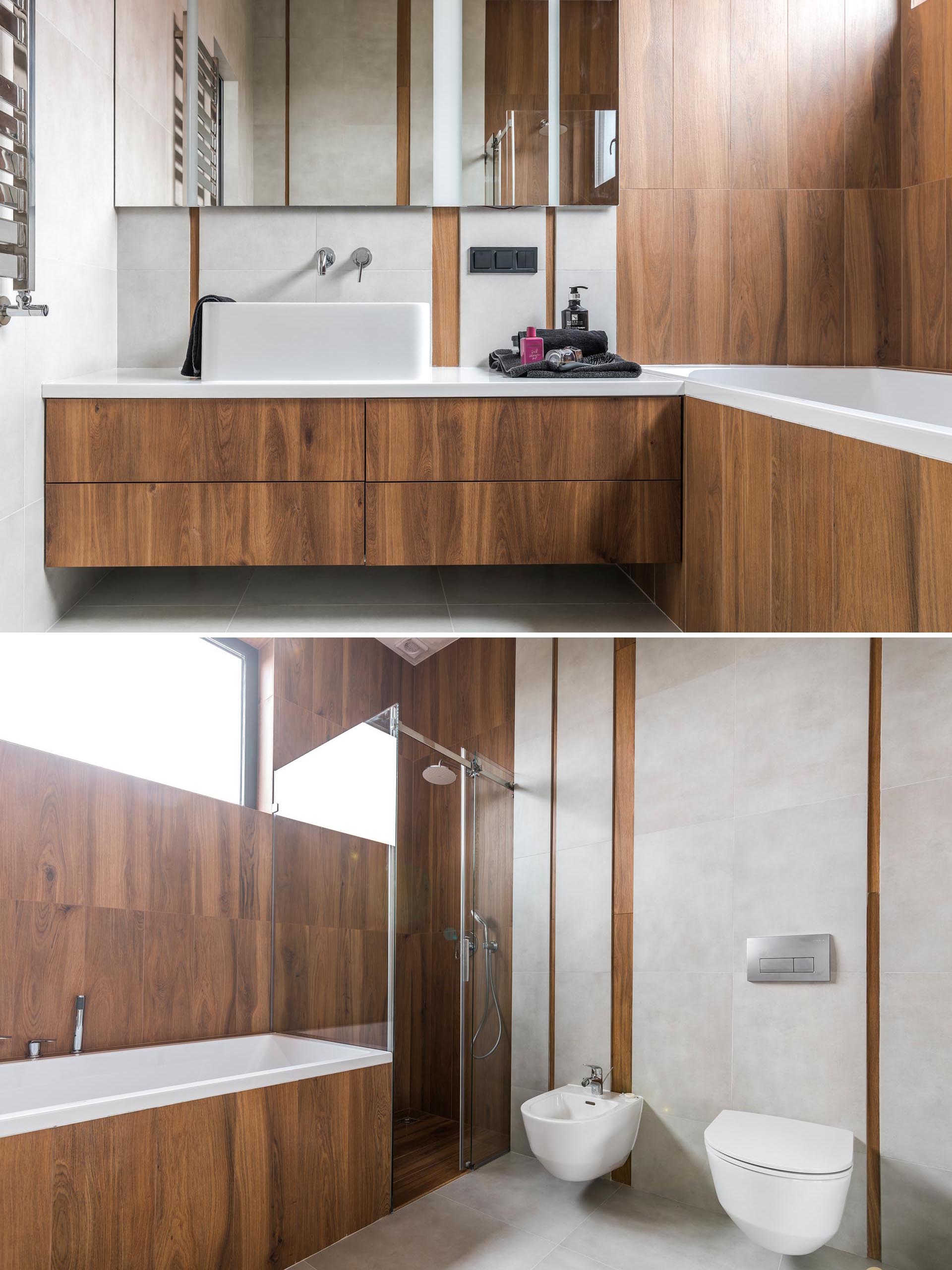 A modern wood-like tile covers a bathroom that also includes a white counter and sink.