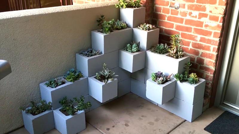 Create your own inexpensive, modern and fully customizable DIY outdoor succulent planter using cinder blocks, landscaping fabric, cactus soil, and succulents.