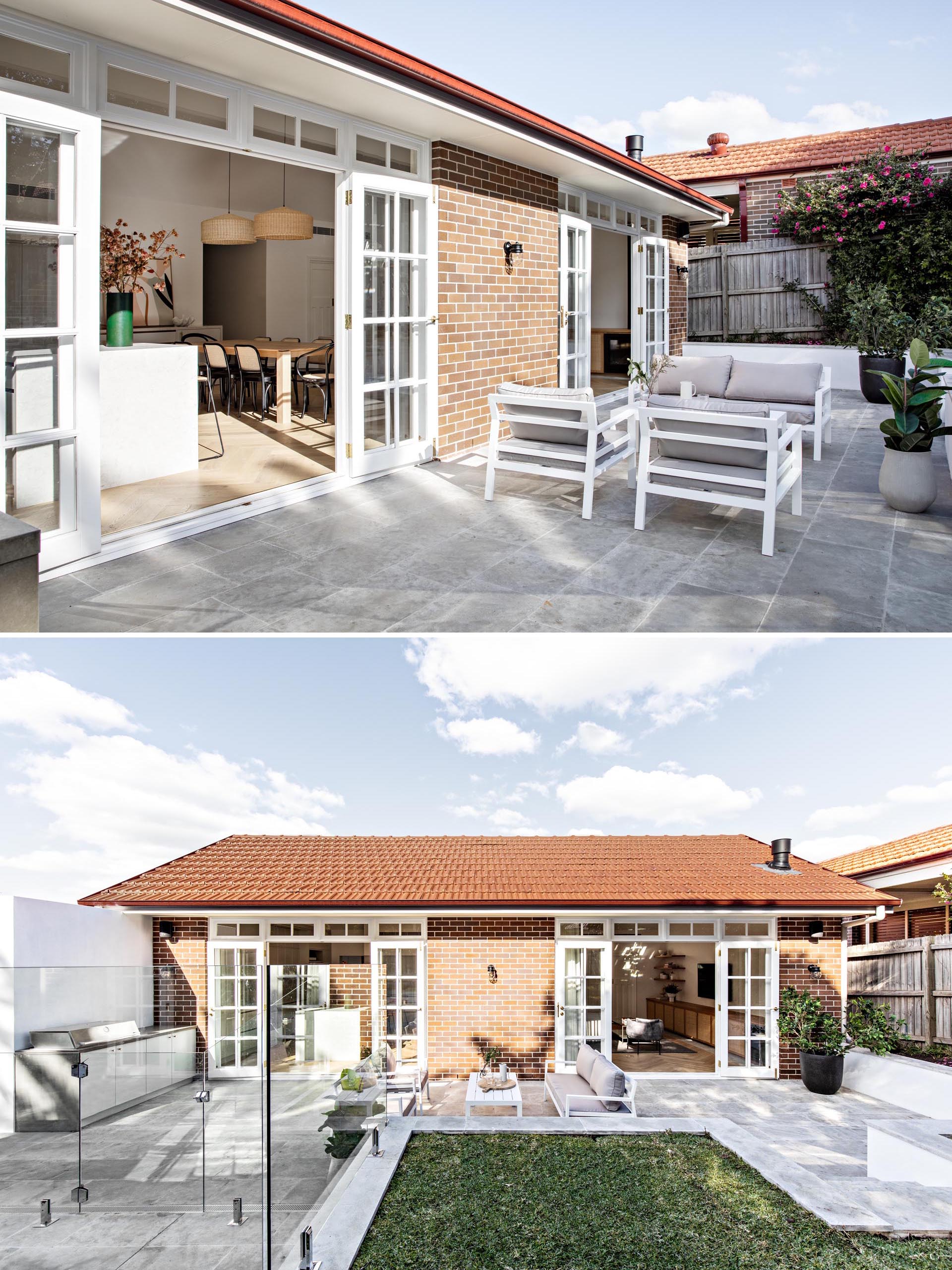 The rear of this home has two sets of french doors that open to a large patio with outdoor seating and a designated bbq area.