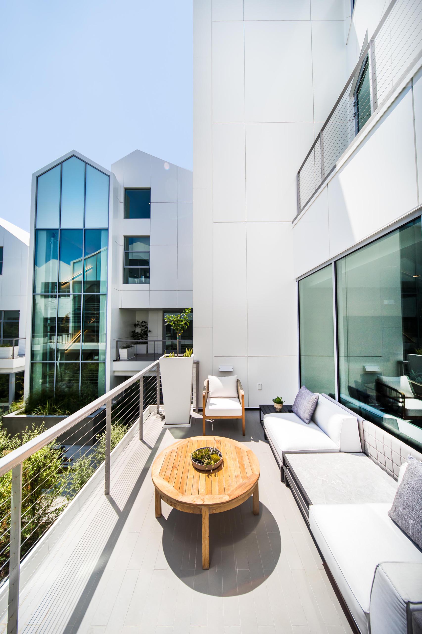 A modern balcony furnished with a sofa.