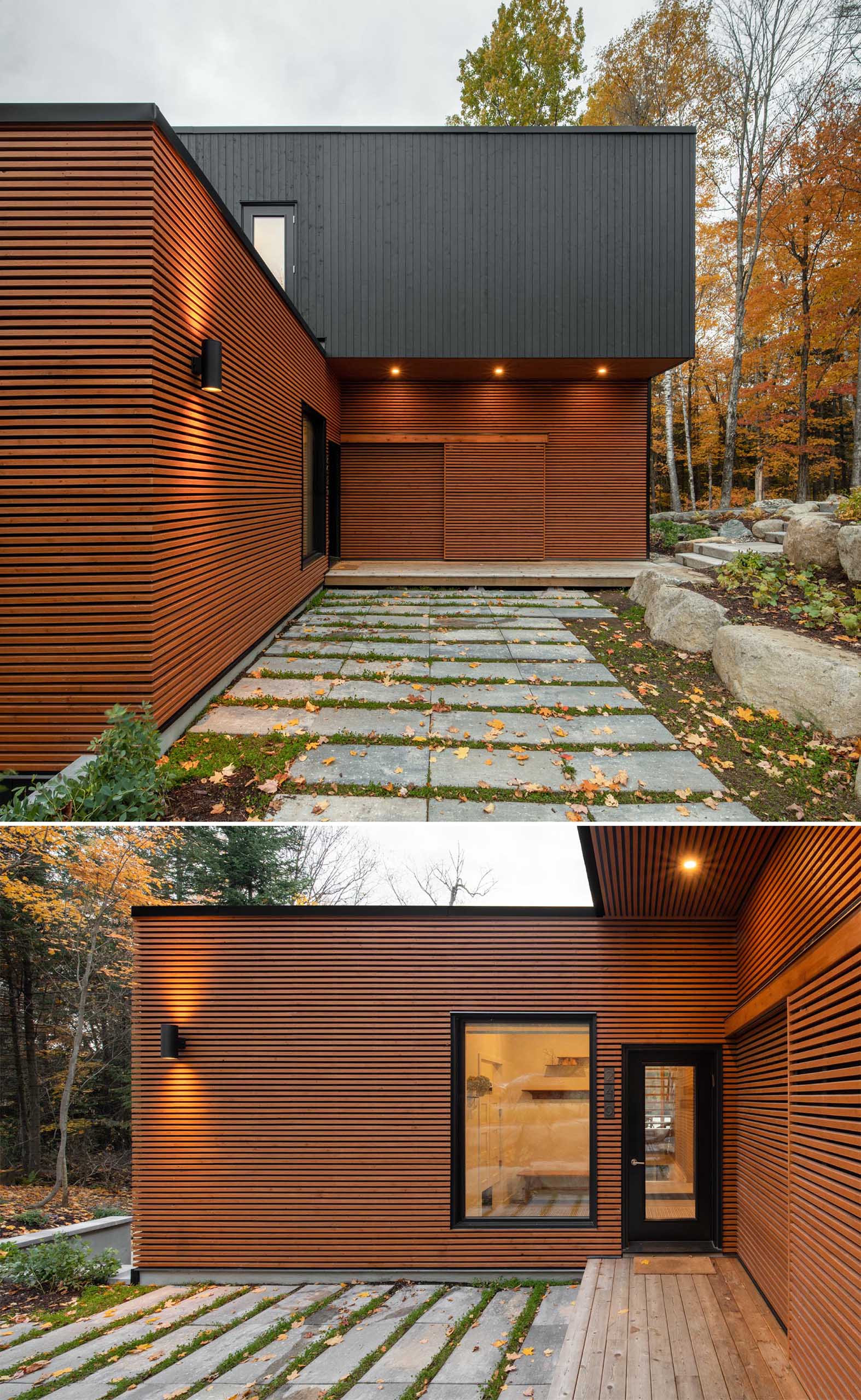 The natural colored exterior of this modern prefab home blends into the wooded area effortlessly, while the opaque black accents add interest.  