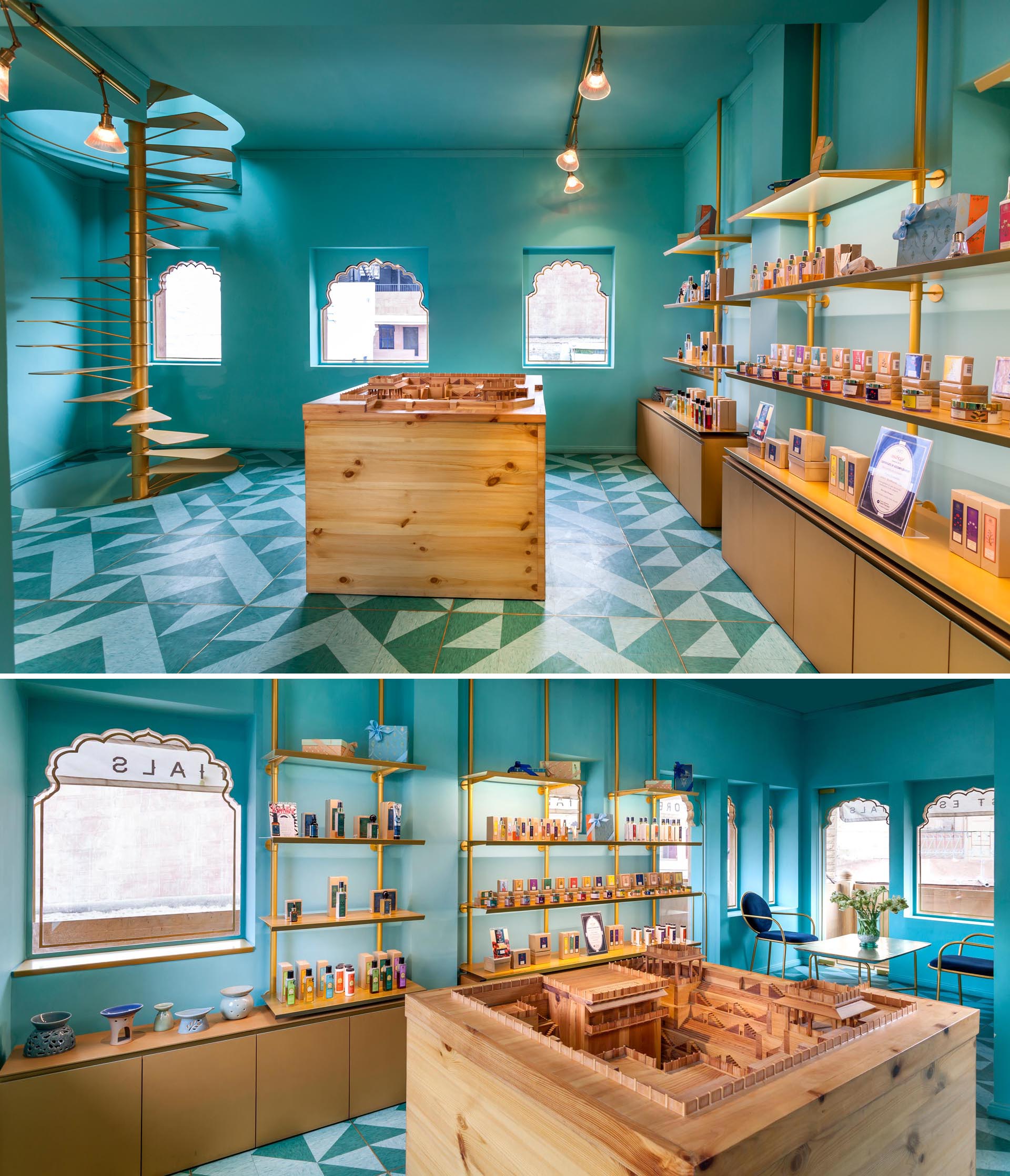 A modern retail store with teal blue/green walls, gold shelving, spiral stairs, and patterned floor.