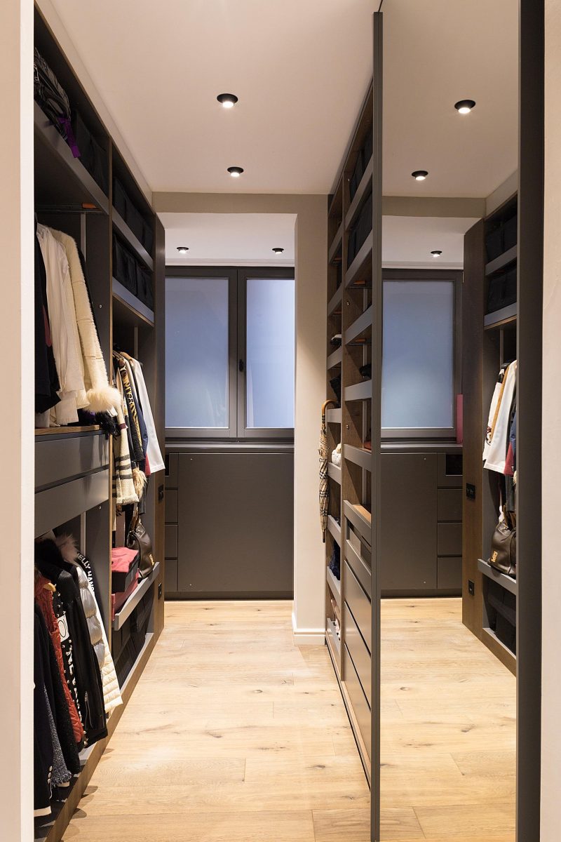 A custom-designed walk-in closet with plenty of storage.