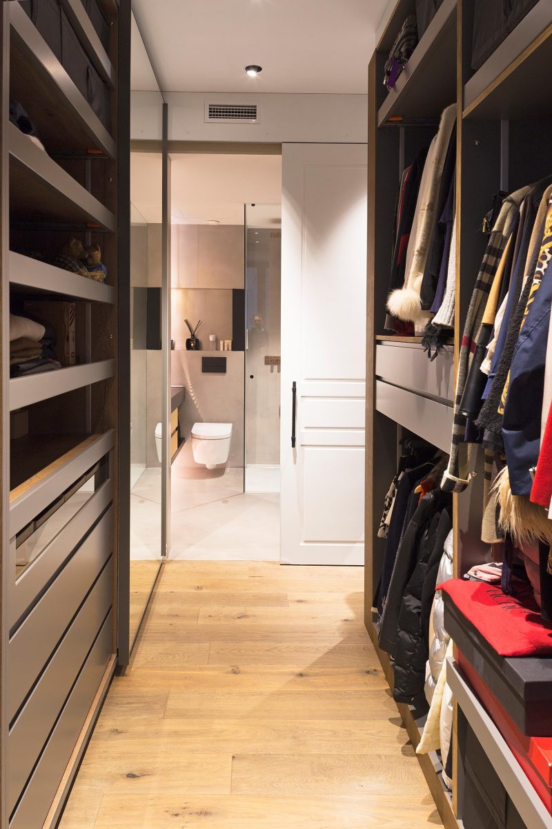 A walk-in closet that leads to the master bathroom.