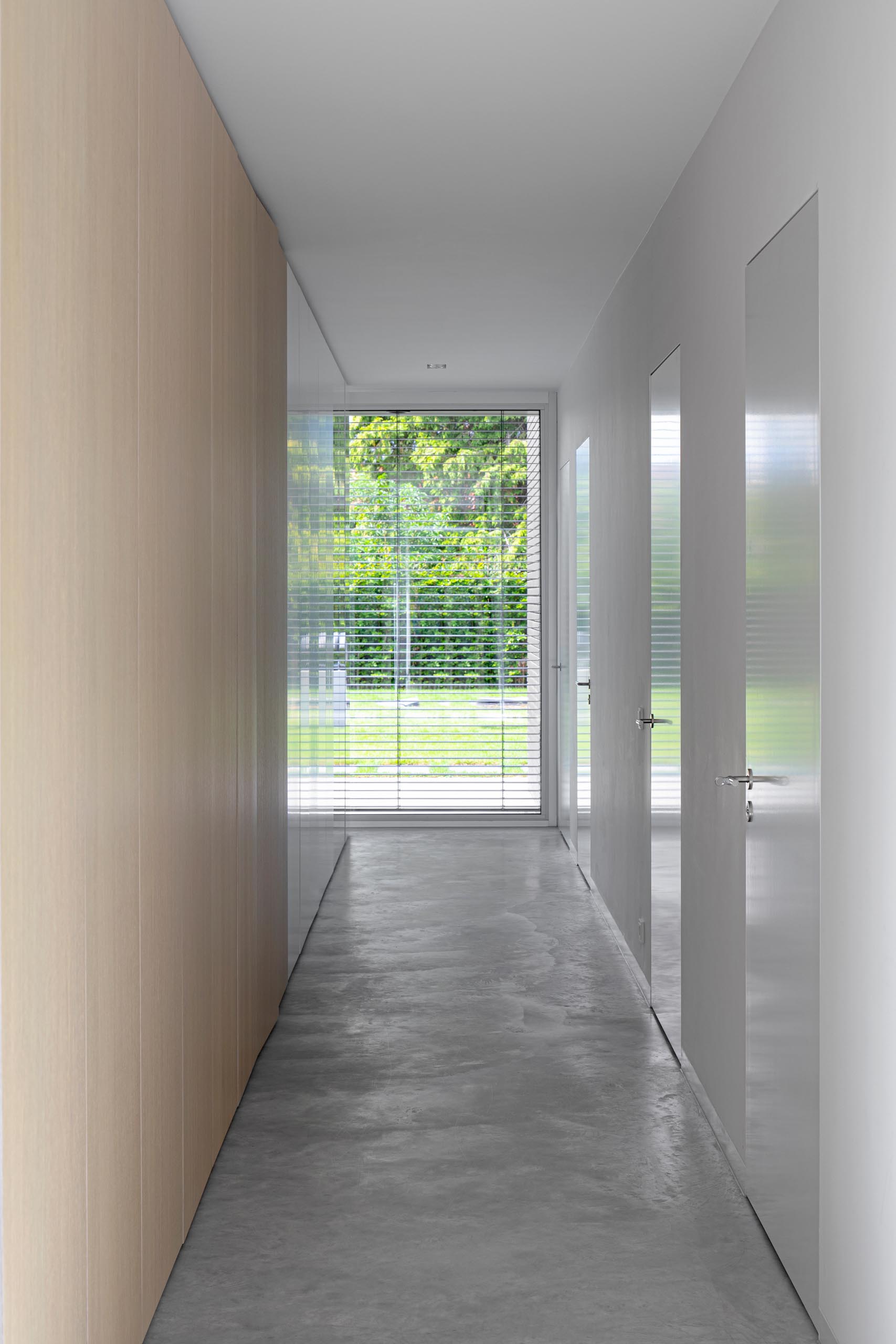 A modern hallway with concrete floors.