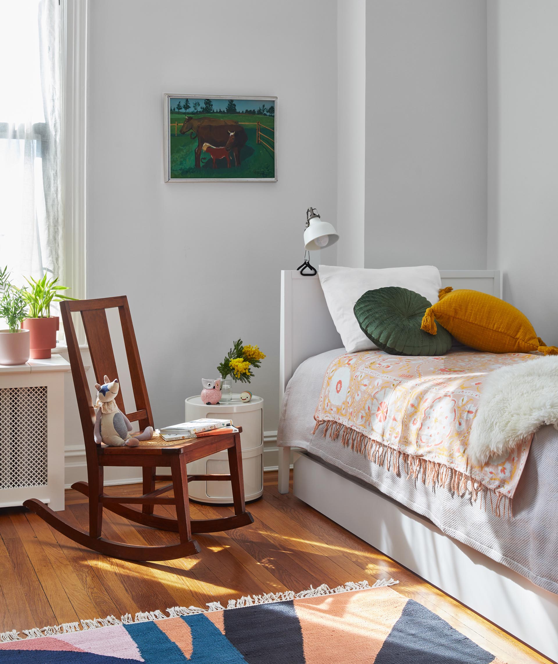 In this kids room, bright and colorful accents stand out against the light-colored walls.