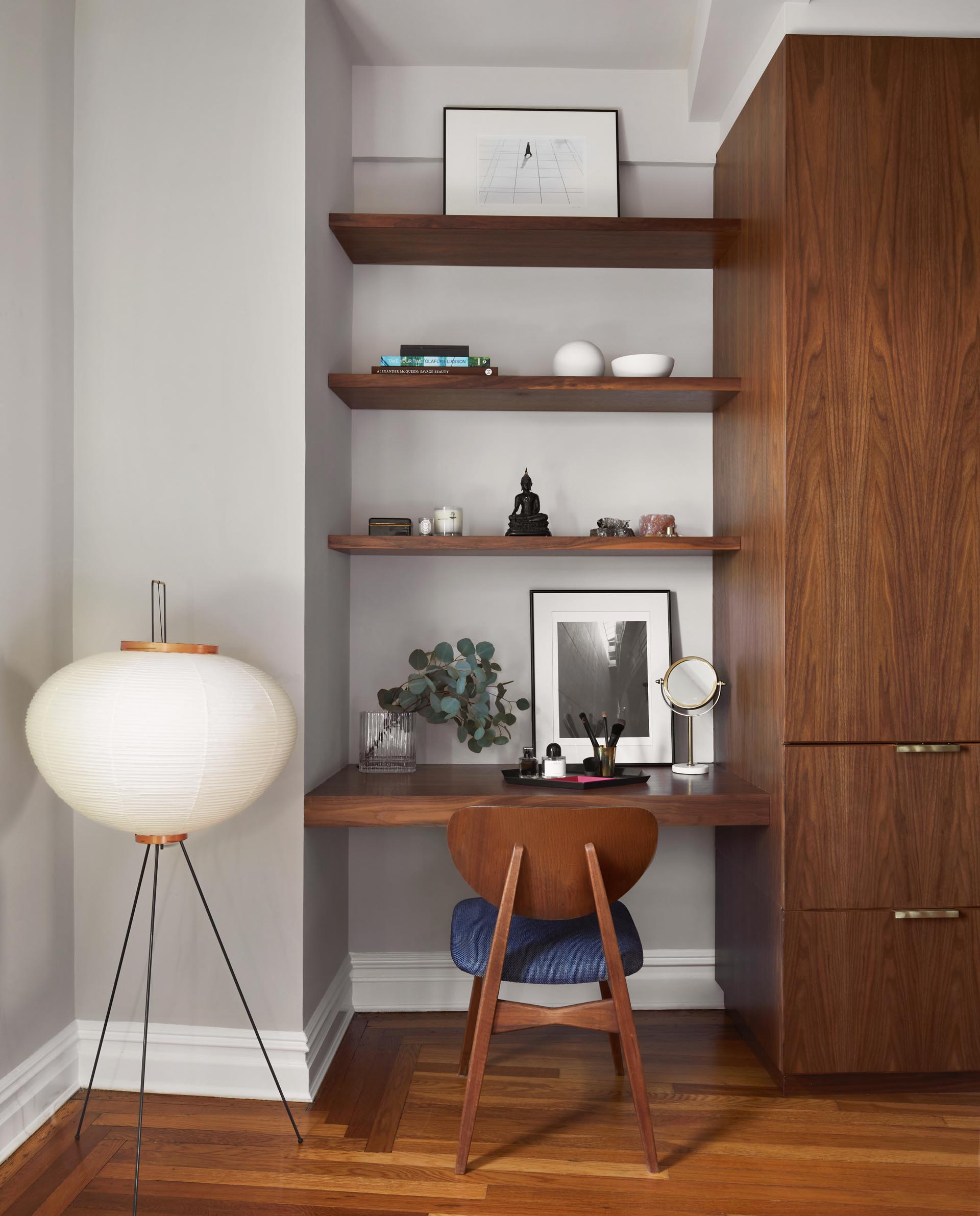 A custom-designed vanity / desk that matches the wood cabinets and shelving.