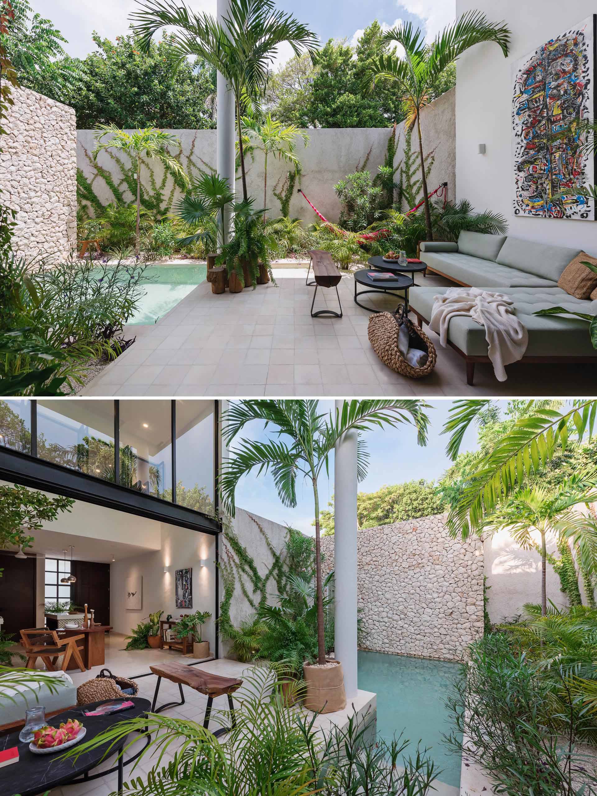 A small house with an outdoor living room, tropical plants, and small pool.